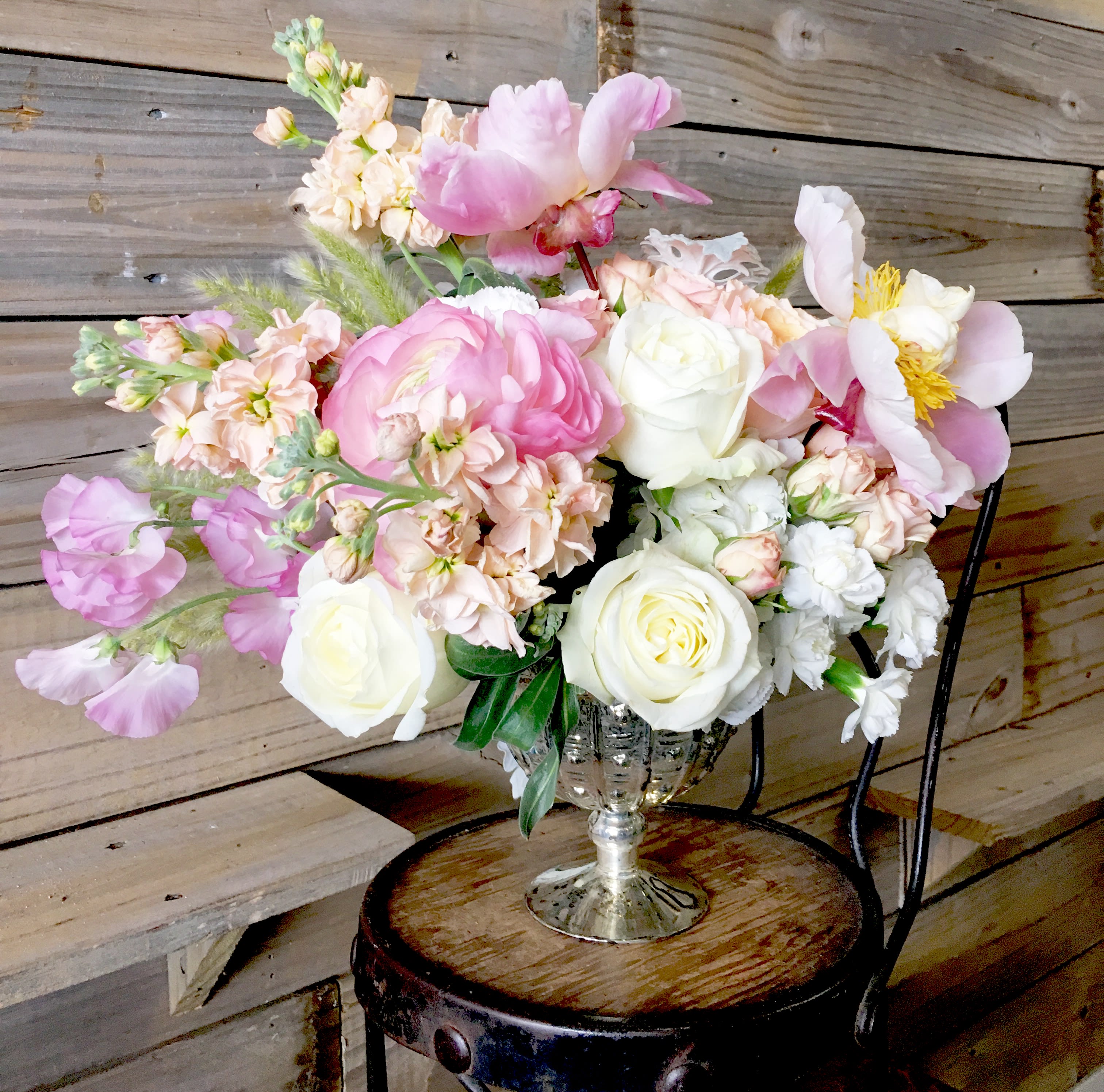 Lush compote arrangement in soft flowers - Roses, stock, sweet peas and peonies are sure to make someone swoon