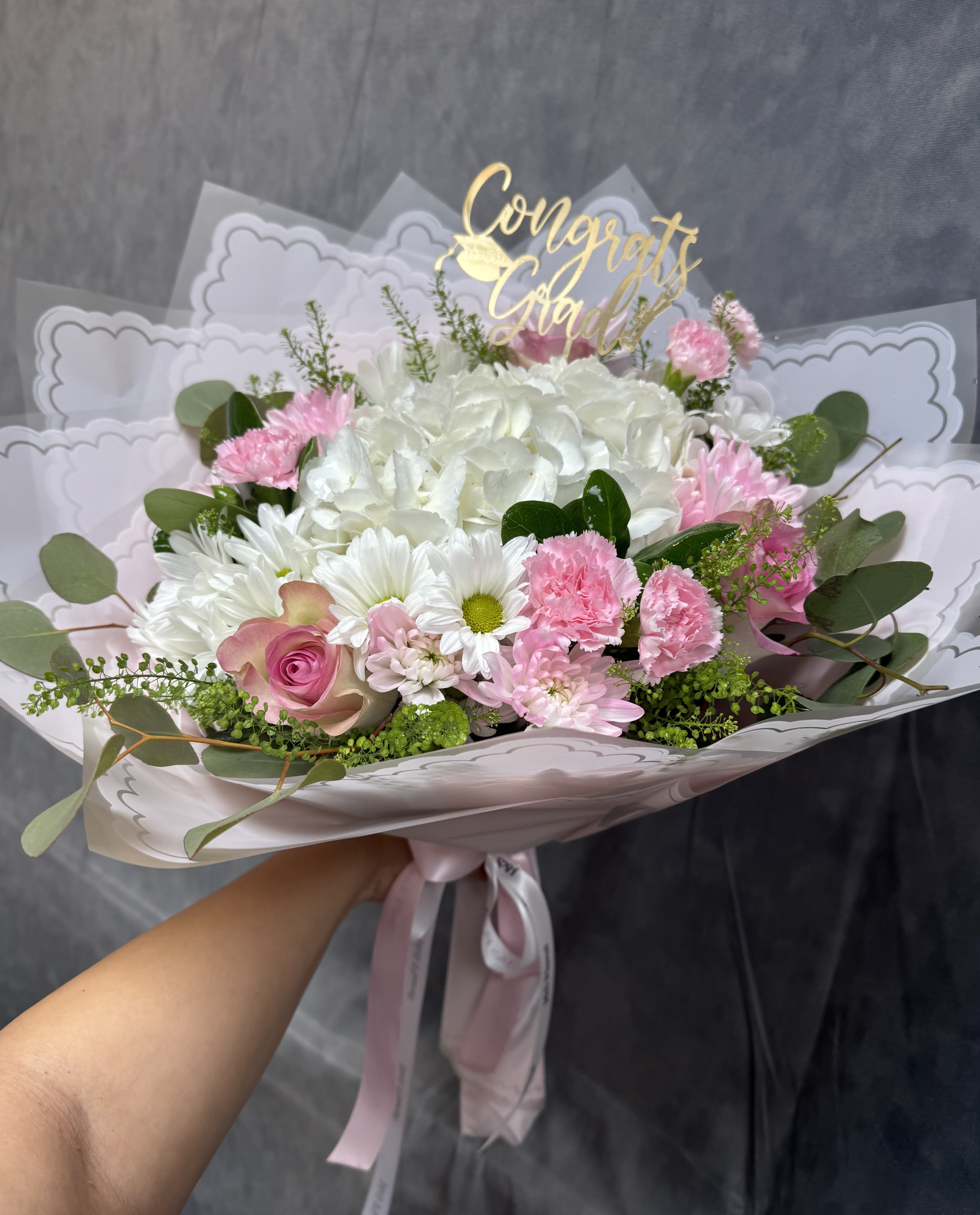 Elegance in Bloom Bouquet  - A timeless arrangement featuring white hydrangeas, soft pink roses, delicate carnations, and charming daisies — a graceful blend of elegance and beauty in every stem.