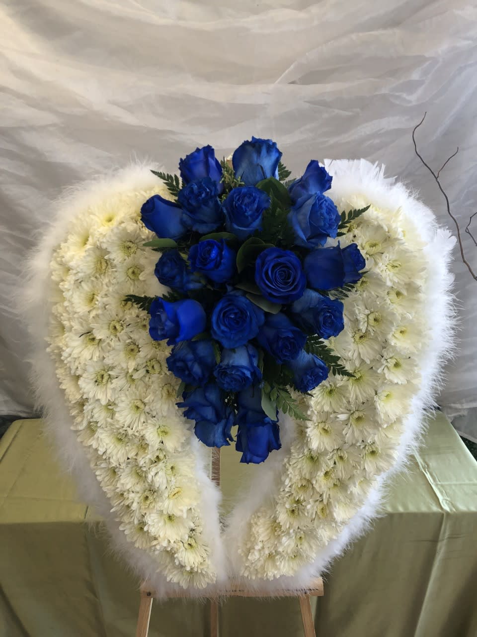 #325  - Blue Angel - This set of angel wings are 24&quot; tall and contains blue Roses and white Chrysanthemums. Easel is not included. 