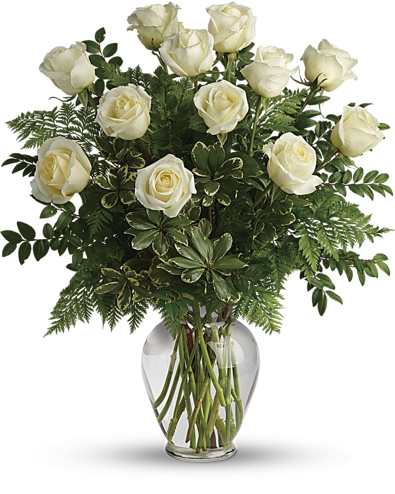 Joy Of Roses Bouquet - A joyful gesture of love and affection this chic arrangement of one dozen pure white roses with fresh greens is a special surprise on any occasion. 12 white roses are arranged with leatherleaf fern huckleberry and variegated pittosporum. Delivered in a clear vase.