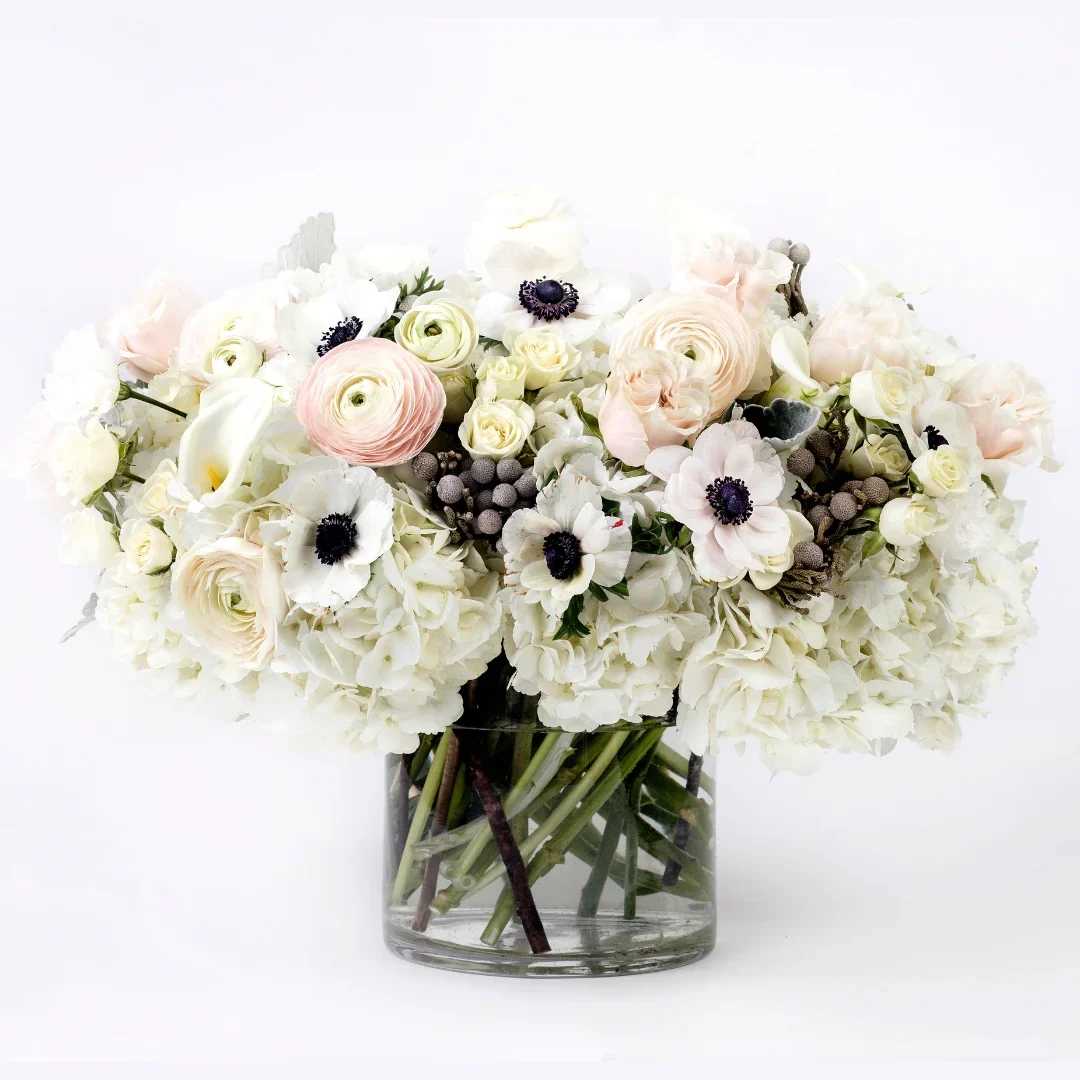 Elara - A soft-spoken stunner of Anemone, Ranunculus, Hydrangea, Calla Lilies, Brunia, and garden Roses, Elara is a pastel dream in bloom. With creamy textures, delicate pink undertones, and cloudlike fullness, it captures a feeling of lightness and quiet affection—offering beauty that soothes, uplifts, and endures.  