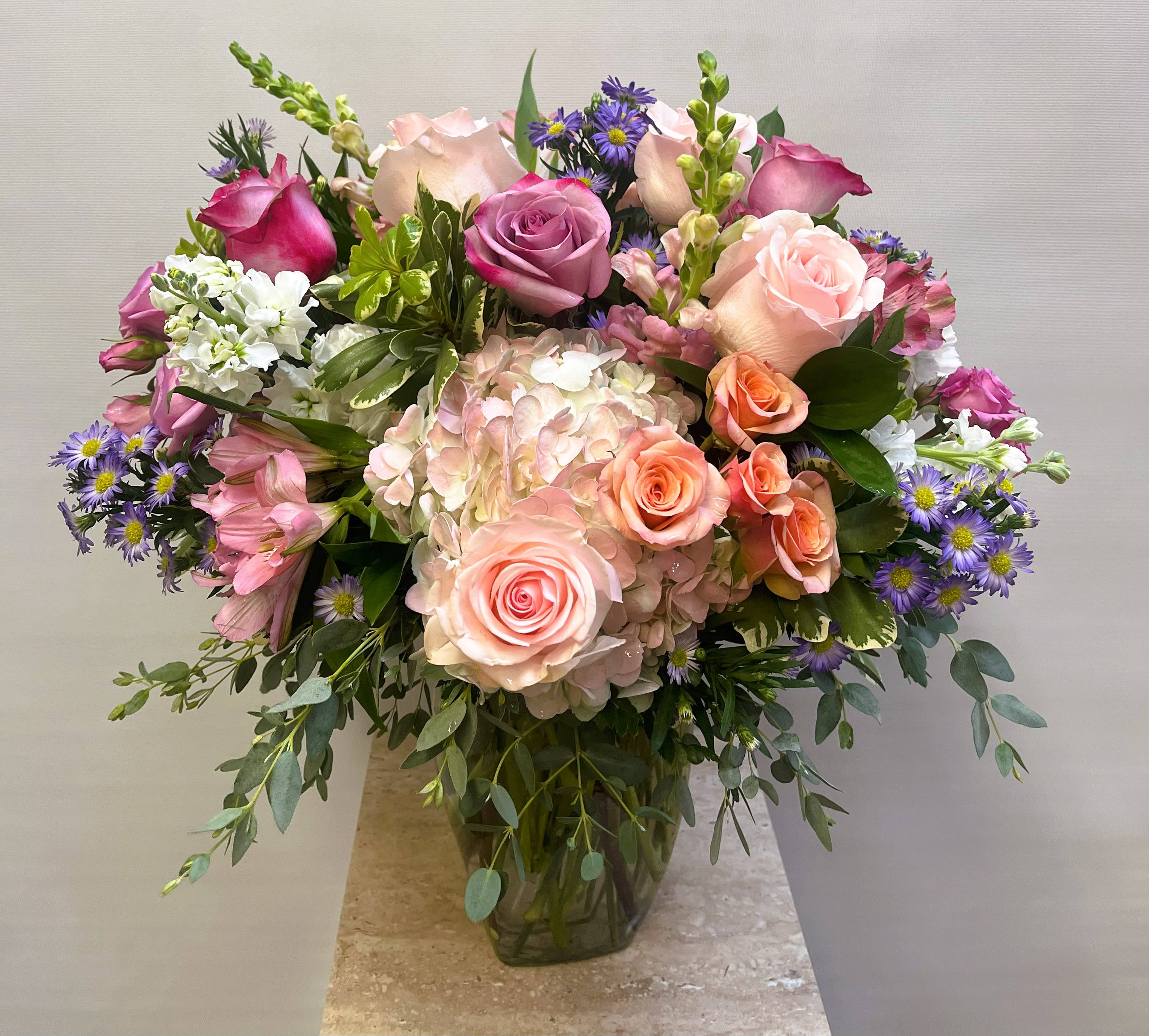 Pink Bouquet Pink Bouquet - A classic vase arrangement that has a variety of pink, purple, and white flowers.