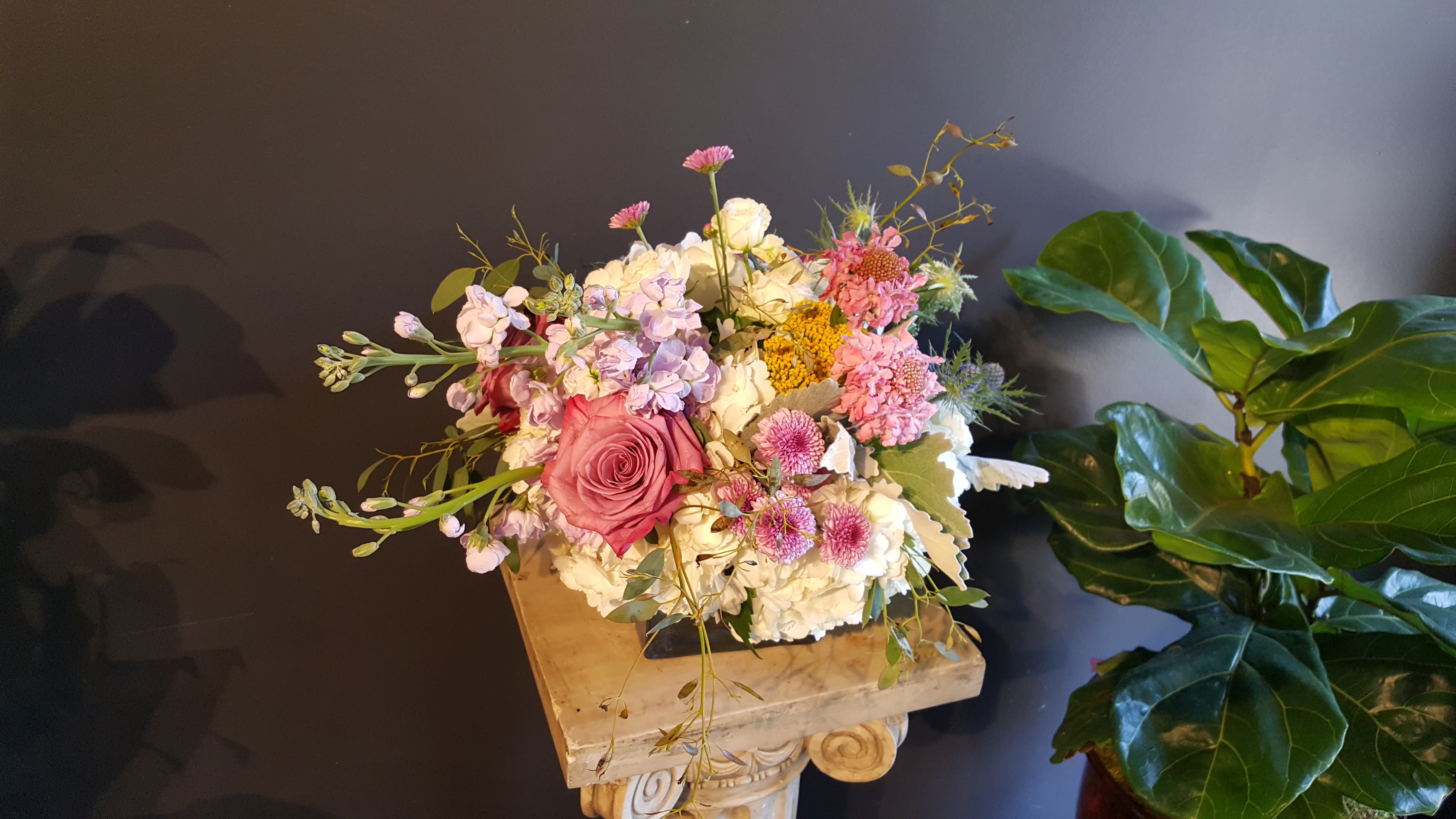 SG-11 - This is one of the arrangement that picture doesn't justify the beauty of the arrangement. Med- sized flower arrangement arranged in a clear vase.  Due to various seasonal and regional conditions, and the variety of unplanned issues courtesy of Mother Nature, availability of some flowers may be very limited in certain areas.  In this event, we will substitute with a second choice of similar flowers and container of equal value and beauty. Every effort will be made to maintain size, shape, and overall color schemes of an arrangement. Our goal is your complete satisfaction, rest assured that every effort will be made to provide an arrangement of equal or greater value. 