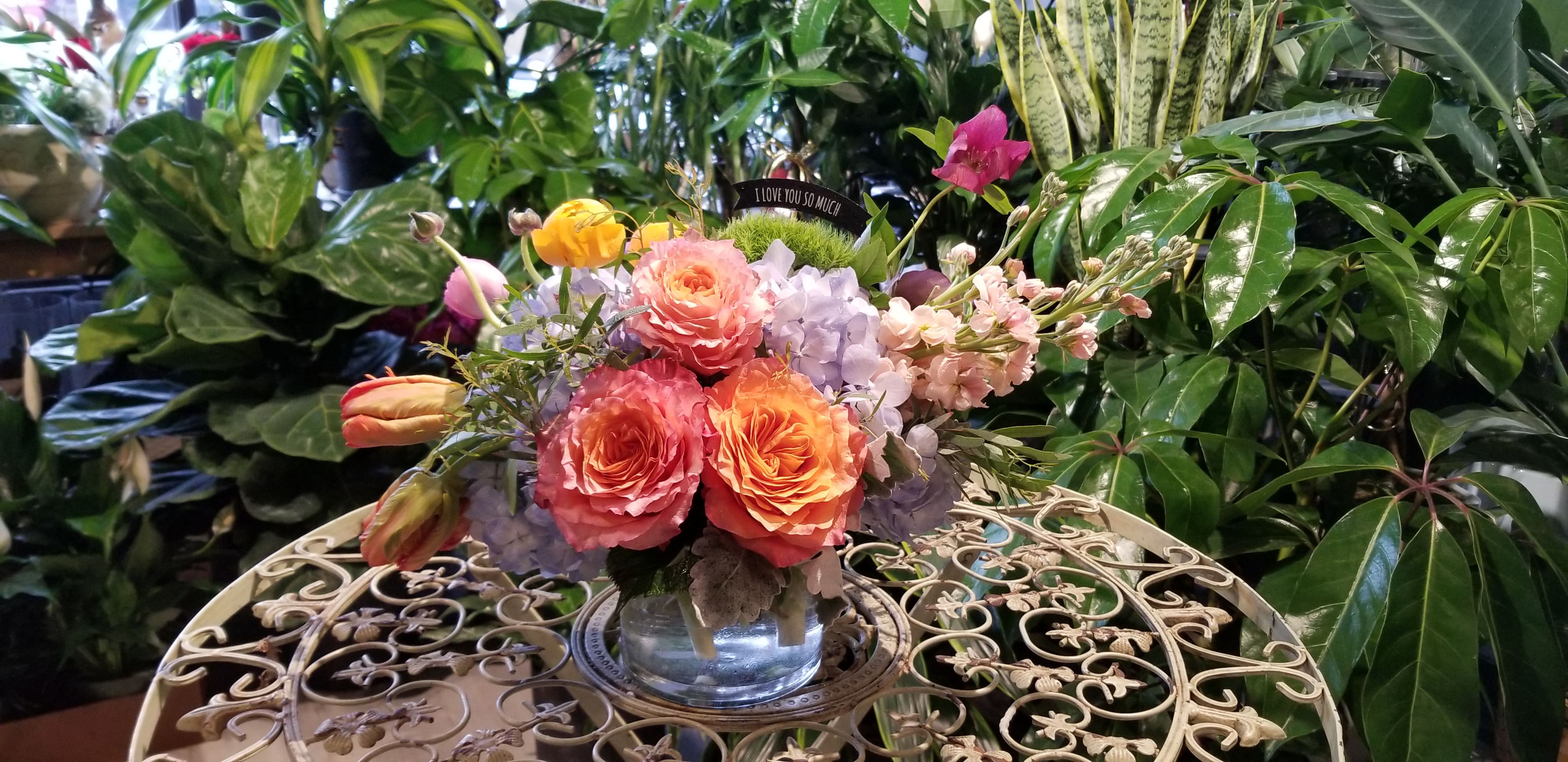 Make her day - ** This is a small arrangement but its beauty is as big as it can be. Arranged in a clear cylinder vase or a white ceramic vase. ** If you want this style with no vase but wrapped with our signature presentable hand-bouquet style, please leave a note for florists when you check out.  Due to various seasonal and regional conditions, and the variety of unplanned issues courtesy of Mother Nature, availability of some flowers may be very limited in certain areas.  In this event, we will substitute with a second choice of similar flowers and container of equal value and beauty. Every effort will be made to maintain size, shape, and overall color schemes of an arrangement. Our goal is your complete satisfaction, rest assured that every effort will be made to provide an arrangement of equal or greater value.