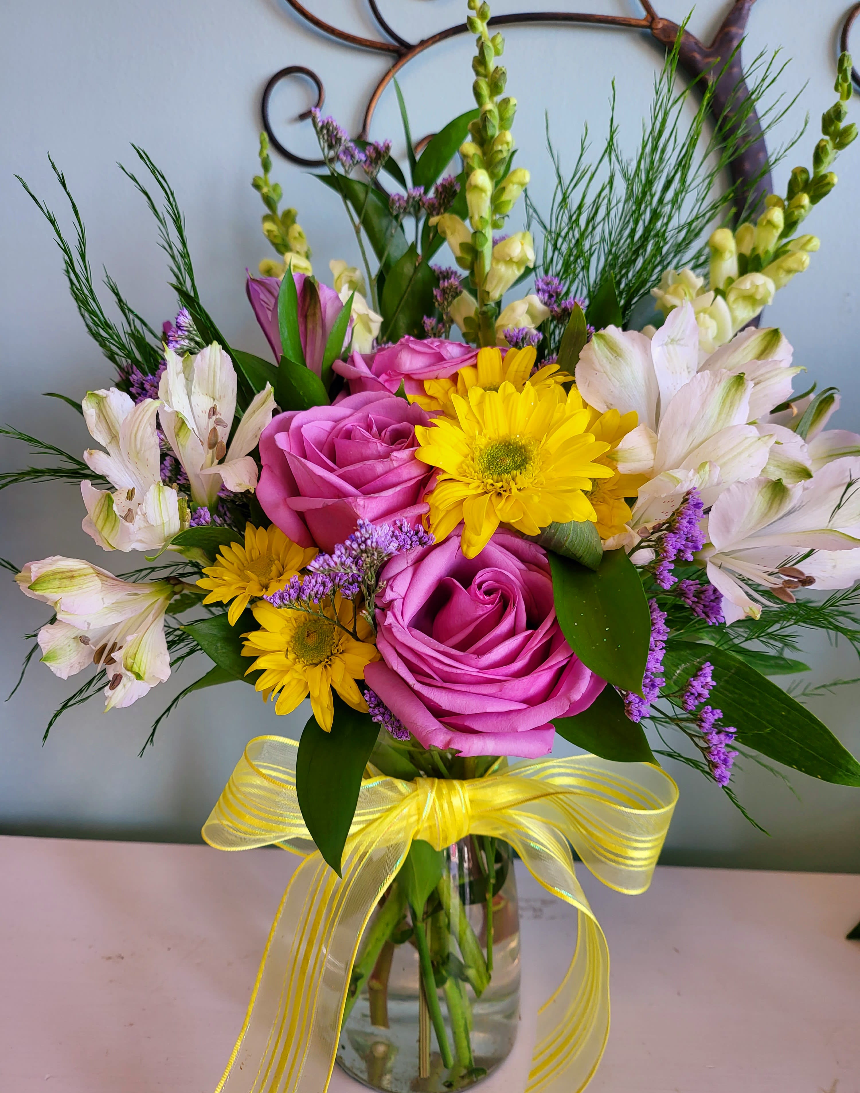 Delightful Moments - A wonderful mix of colorful flowers and a keepsake mike jug, Make anyone smile with delight. Colors and flowers will vary depending on time, season, and availability of fresh in stock.