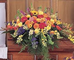 TF 203-7 Half Couch Casket Spray - Casket Spray with sunflowers, roses, carnations, gerbera daisies, snapdragons, delphinium and a variety of greenery