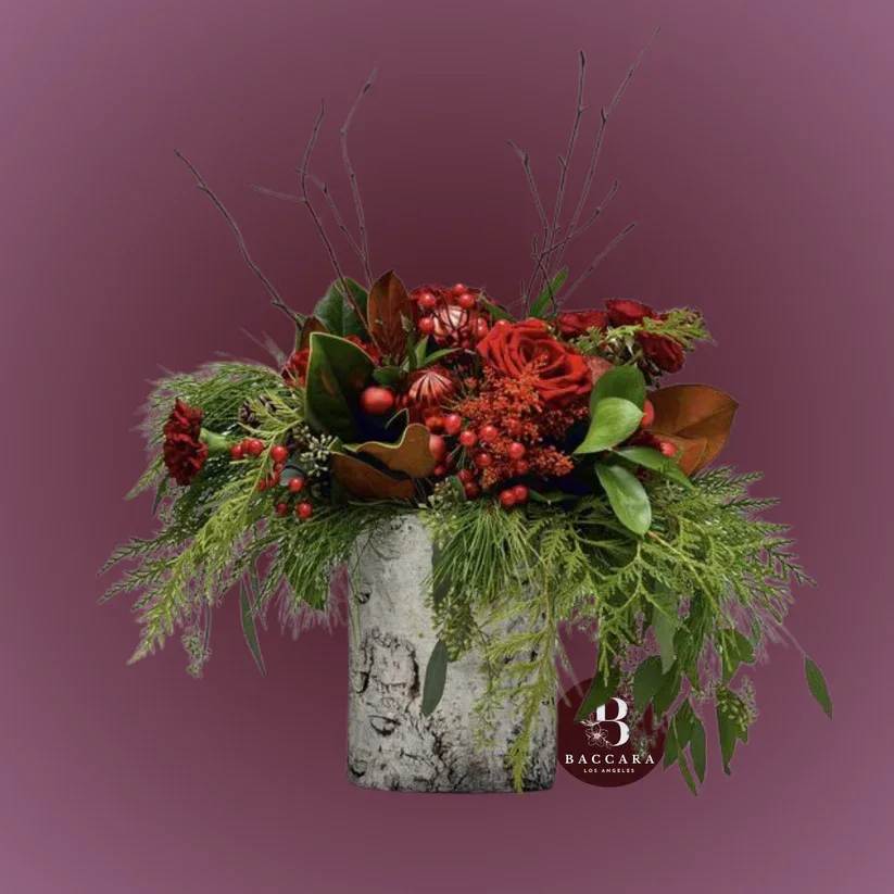 Winter Forest Escape: Seasonal Floral Arrangement - Immerse yourself in the serene beauty of winter with our Winter Forest Escape floral arrangement! This enchanting display captures the essence of a snowy woodland, featuring a mix of lush evergreens, frosted pine cones, and delicate white blooms that mimic the tranquility of a winter forest. Accented with hints of silvery foliage and twinkling lights, this arrangement creates a peaceful and inviting atmosphere. Perfect for your holiday decor or as a thoughtful gift, let this stunning centerpiece bring the magic of the winter woods into your home!  Disclaimer: Product images are for reference only. Actual flower shades, box colors, and arrangement styles may vary slightly based on seasonal availability and stock. We always strive to match the overall style, color palette, and quality shown in the photos, ensuring every arrangement is fresh, beautiful, and thoughtfully curated.