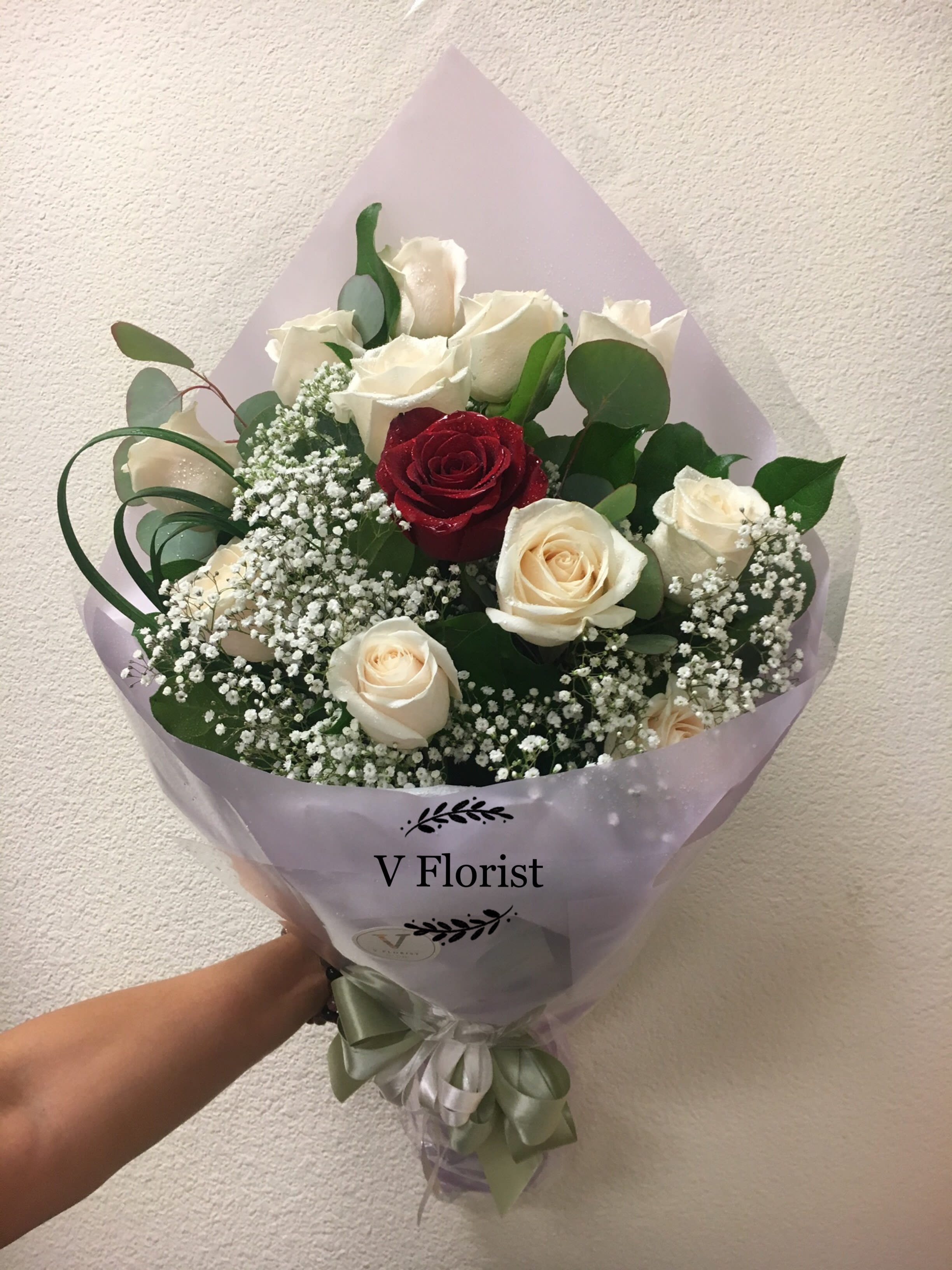 The Only One Bouquet - 11 white roses with one single red rose in the middle, wrapped in a hand-hold bouquet with babies' breathe and greens. Best for surprises, and date night.  Our florists select the freshest flowers available, so colors and varieties may vary due to local availability.