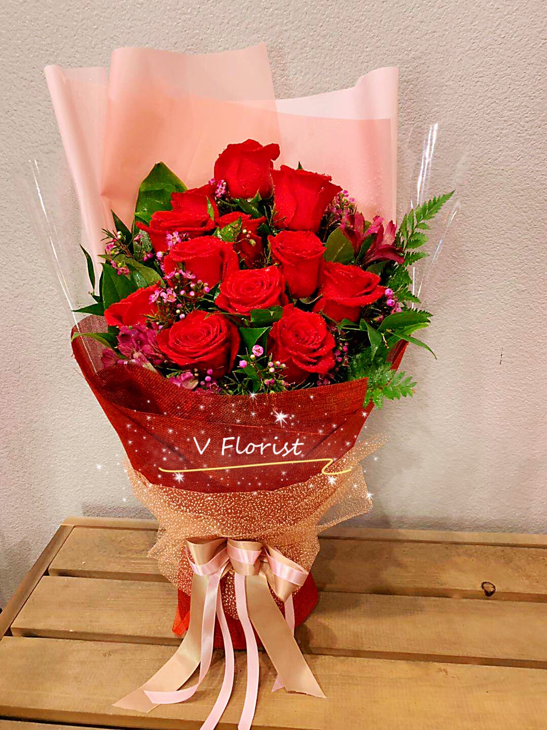 Deluxe red roses wrapped bouquet - Choice of 12 red roses with fillers. Wrapped in the unique Asian style bouquet