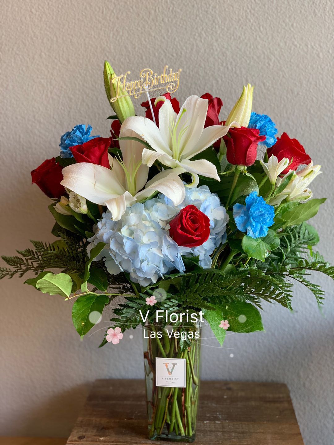 Big Surprise Arrangement Big Surprise Arrangement - Rose, Lily, Hydrangea, carnation, and alstroemeria joined together for the big birthday surprised. Put together in a 10" vase makes this an amazing arrangement as a dining table or desk decoration. Colors and availability of flowers depend on seasons. The arrangement does not include the Happy birthday sign.