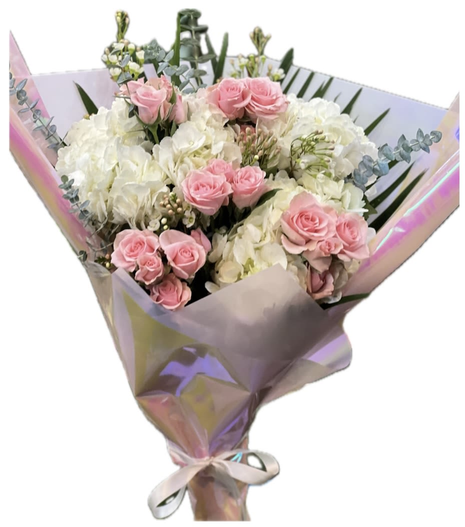 Pretty in pink  - This one-face floral loose Bouquet arrangement features a harmonious blend of white hydrangeas, and pink spray roses, creating a soft and cheerful display. The white hydrangeas add a soft touch while the delicate pink spray roses  bring a touch of sweetness and texture to the composition. The flowers are artfully arranged to form a balanced, yet dynamic design, with each bloom complementing the others in color and form. Perfect for any occasion that calls for a joyful and uplifting bouquet.  Please note: Vase not included. 