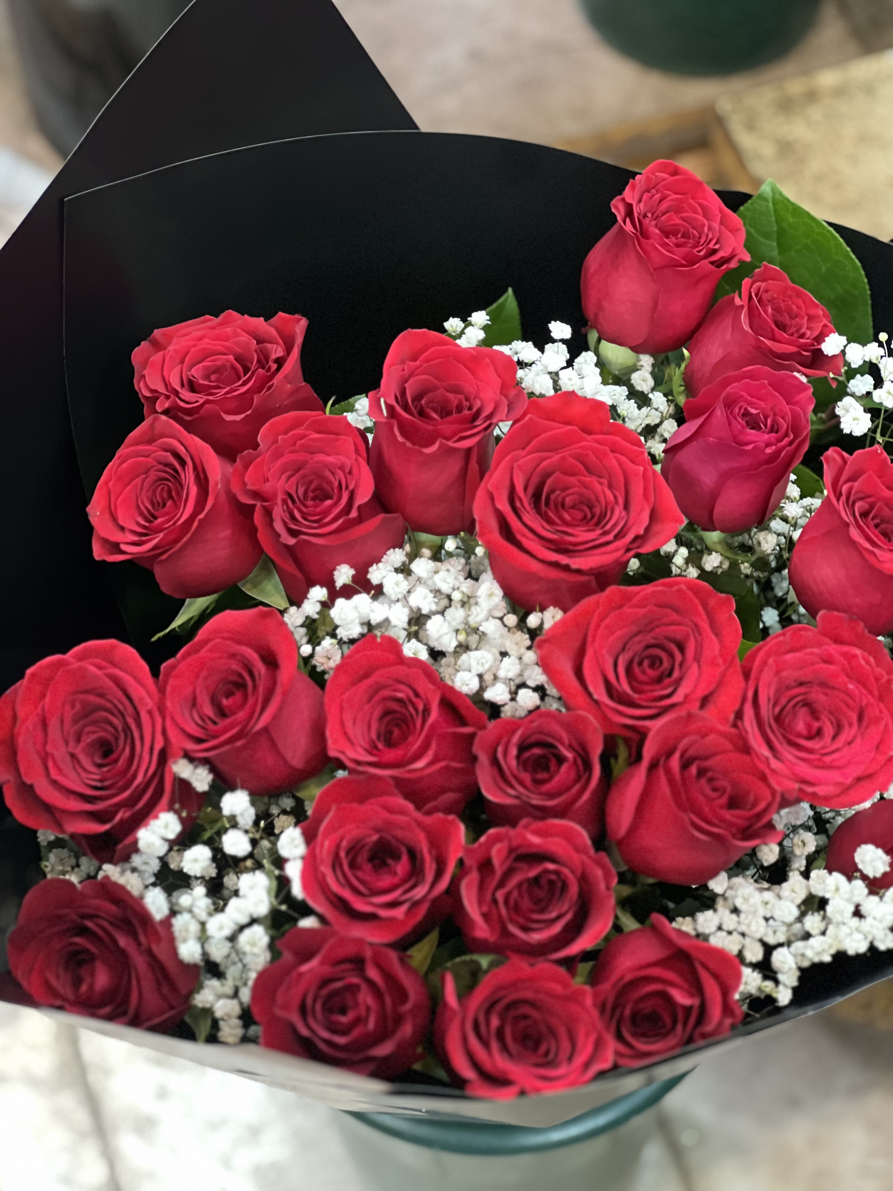 Lasting love  - This loose bouquet of two dozen long stemmed roses is sure to make anyone’s days special! Please note: Vase not included. 