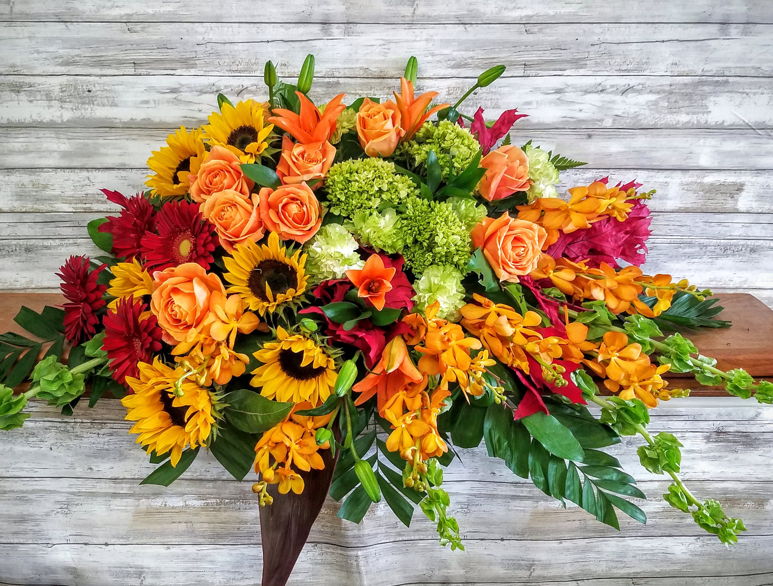 Autumn Memories Half-Size for Open Casket  - For a life that has been joyfully lived, this Autumnal arrangement featuring Sunflowers, roses and hydrangea is an expression of gratitude for shared times together.
