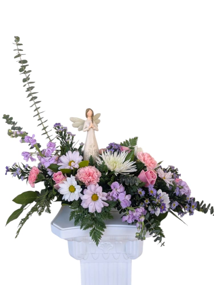 Wings of Peace by Art & Flowers Wings of Peace by Art & Flowers - Wings of Peace is a serene arrangement of soft pastel flowers, centered around an 8-inch keepsake angel. With its gentle beauty and calming presence, this piece offers a meaningful expression of comfort and peace. The angel’s style may vary, making each arrangement uniquely special.