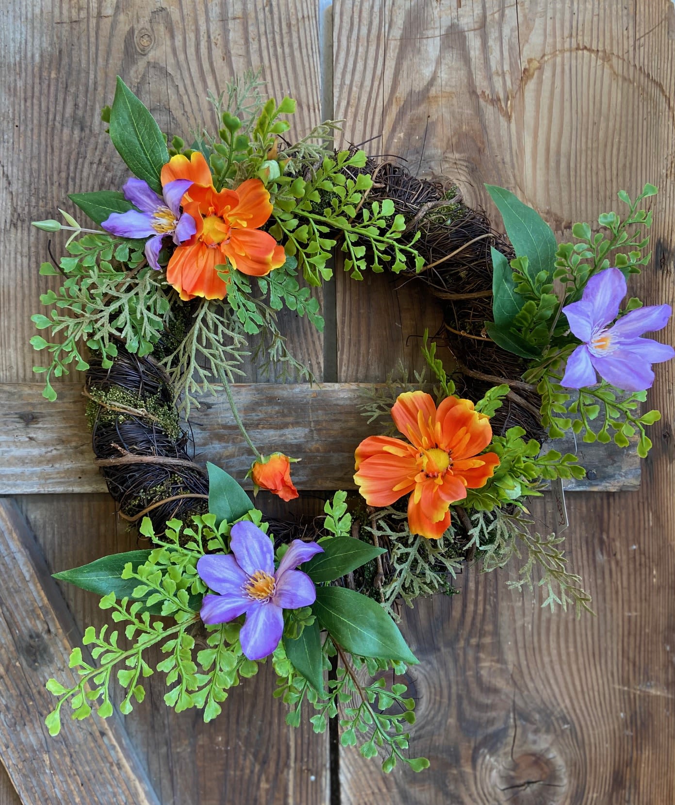 Festive Petite Spring Wreath Festive Petite Spring Wreath - 12” Angel vine wreath base with realistic silk flowers and maiden hair greenery.