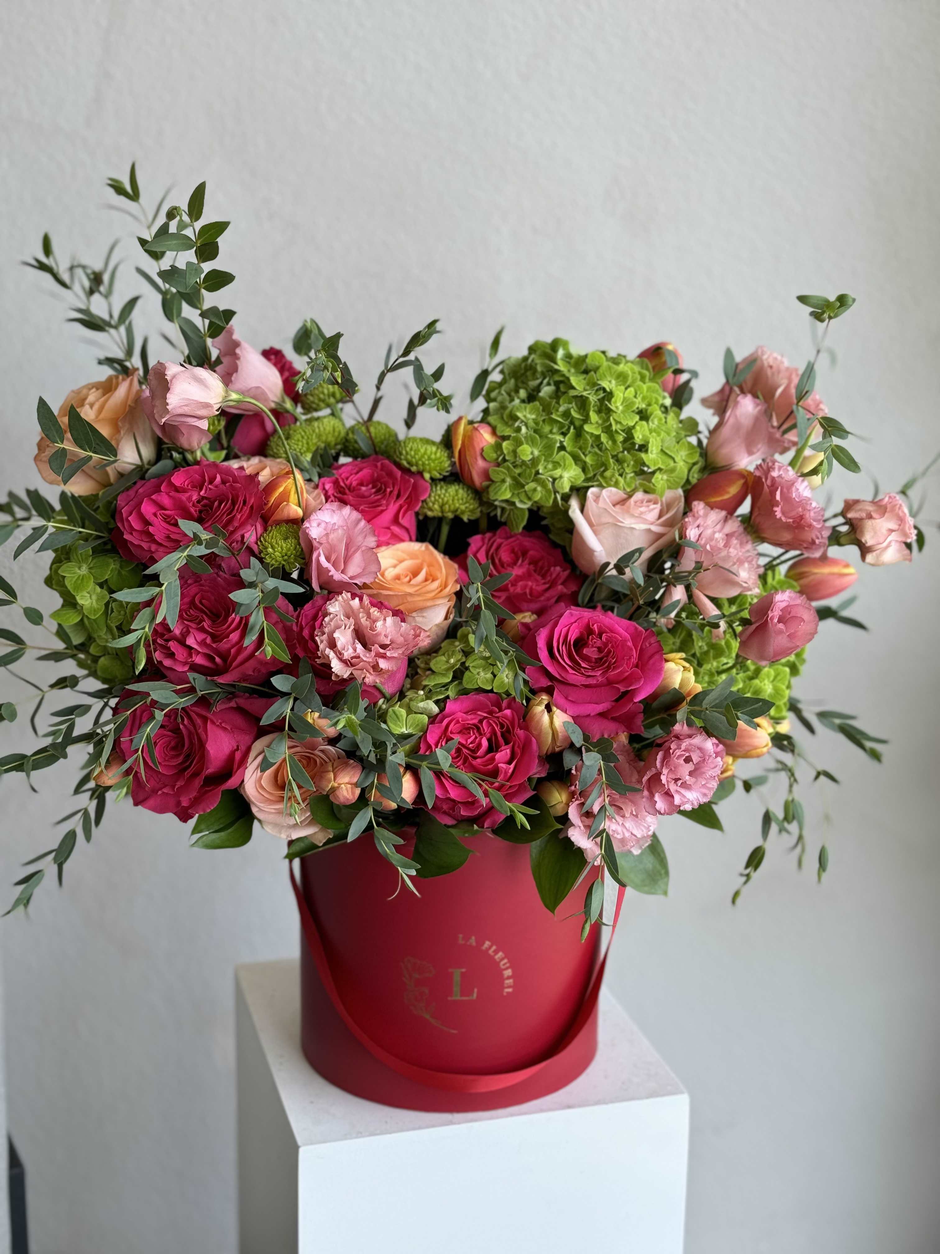 Bright Bloom - A lively arrangement bursting with vibrant colors, perfectly balanced to create an eye-catching display. Nestled in a rich burgundy box, this bouquet brings joy and energy to any space, making it a delightful centerpiece for any occasion.