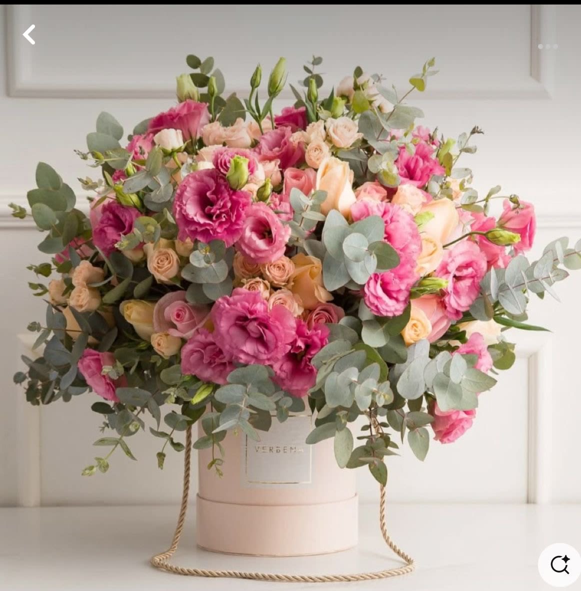 Rosé Luxe Rosé Luxe - A lavish blend of vibrant pink lisianthus, soft peach roses, and silver eucalyptus, elegantly arranged in a blush hatbox—perfect for making a bold, romantic statement.