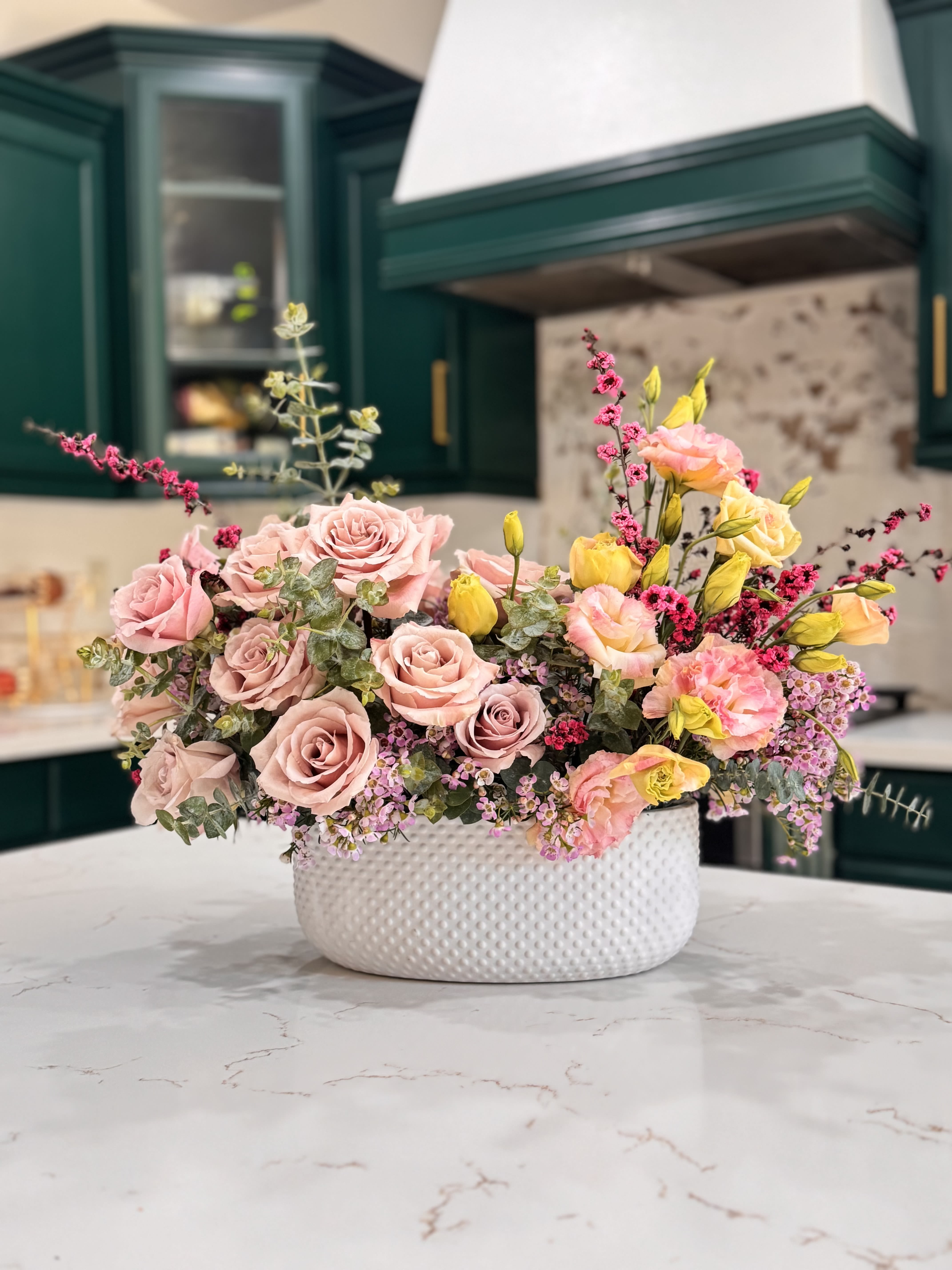 Spring Bloom & Glow Spring Bloom & Glow - A cheerful mix of blush roses, lisianthus , and soft spring blooms arranged in a modern white ceramic vase.