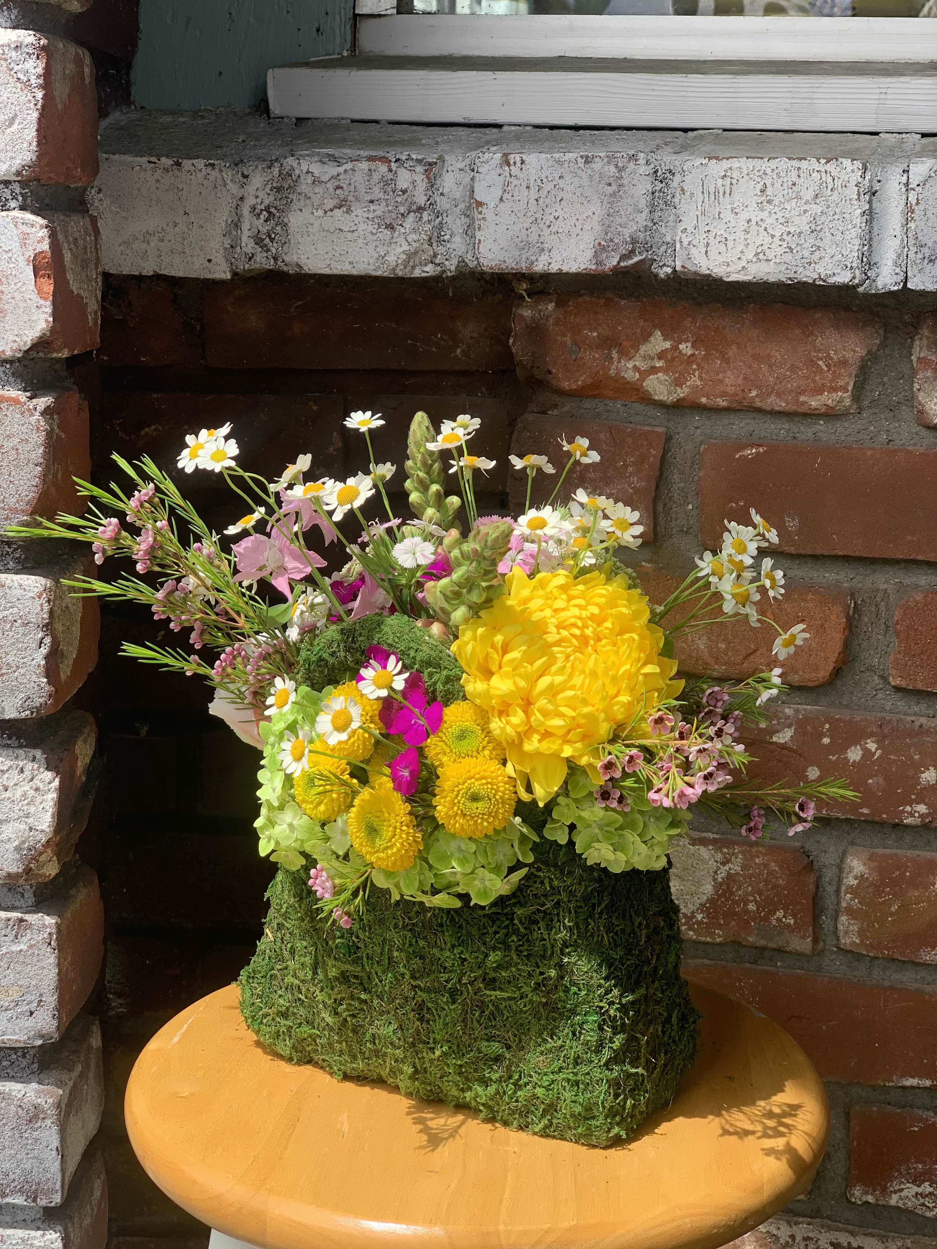 Fairy's Handbag - The handbag is made of moss and filled with a whimsical inspired combination of flowers. We imagine any fairy would love this addition to their wardrobe. Send it to the fairy in your life!