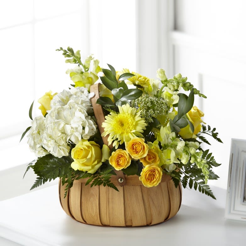 Rustic Remembrance Basket - Our Rustic Remembrance Basket is designed to share an expression of hope, grace and comfort within each yellow bloom. While it is perfectly sweet in size, it is best suited for a small table or within a residence.