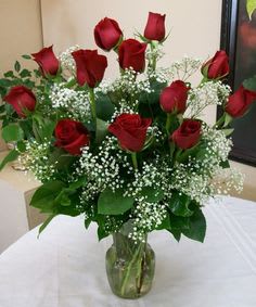 Dozen Red -  SUBSTITUTION POLICY: In some instances, our photo may represent an overall theme and includes a one-of-a-kind vase which cannot be exactly replicated. Although the actual arrangement may not precisely match the photo, it will be as close as possible. Occasionally, substitutions of flowers and/or containers happen due to weather, seasonality, and stock availability.  If any design elements are of major importance to your order, please include them in the florist instructions at checkout our contact us to ensure availability.