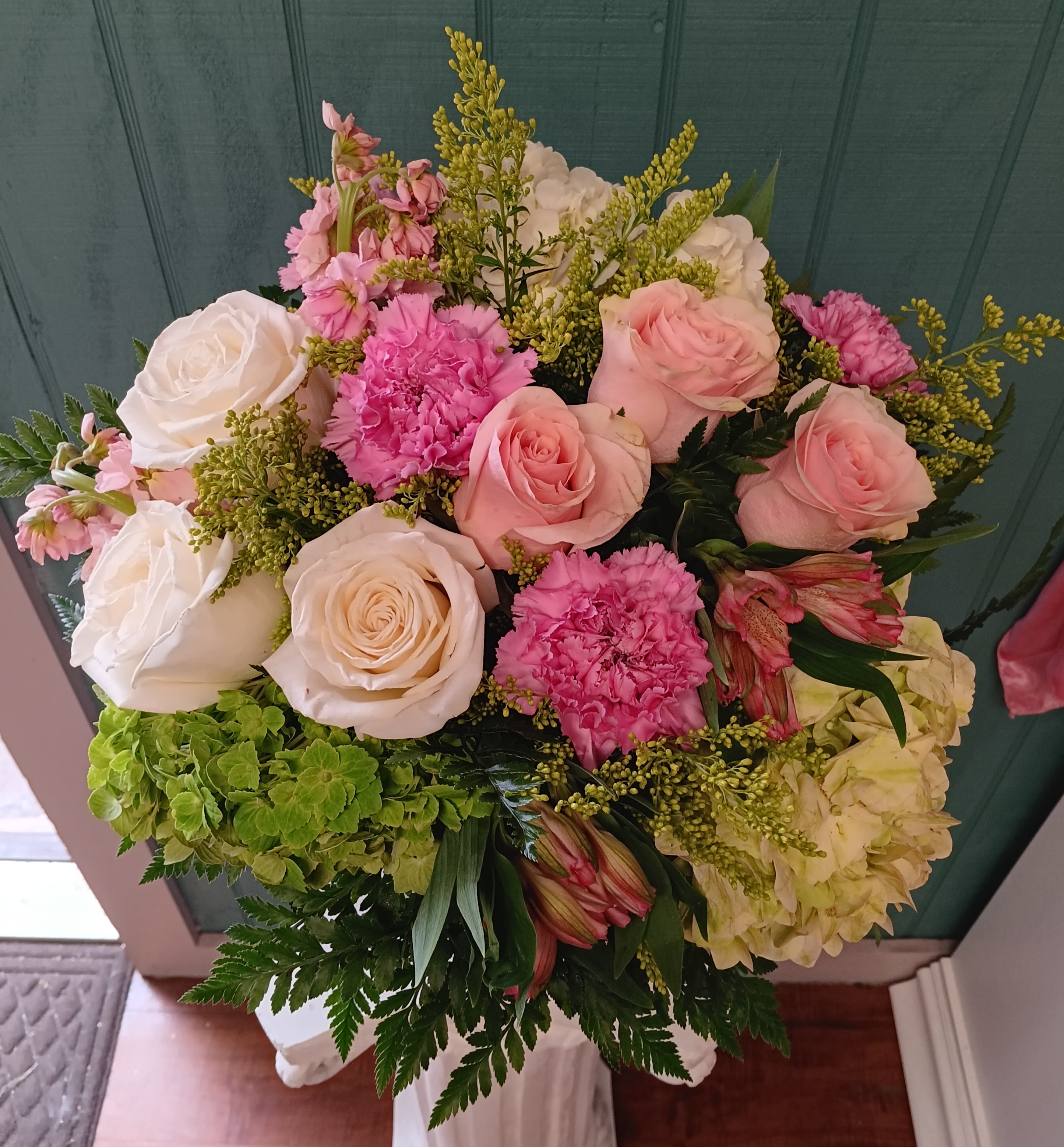 My Luxurious Lady - Celebrate elegance and charm with My Luxurious Lady, a stunning floral arrangement perfect for the special lady in your life. Showcased in a classic clear milk jug container, this bouquet features soft pink and white roses, delicate pink carnations, and lush greens, all complemented by the luxurious touch of voluminous hydrangeas. Tied together with a double satin ribbon, this arrangement radiates timeless beauty and sophistication, making it the perfect gift to express love and admiration.