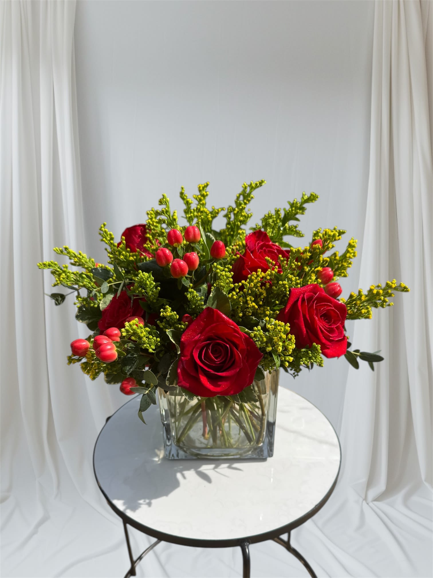 Red Ruby - Premium red roses accented with hypericum berries and solidago. 