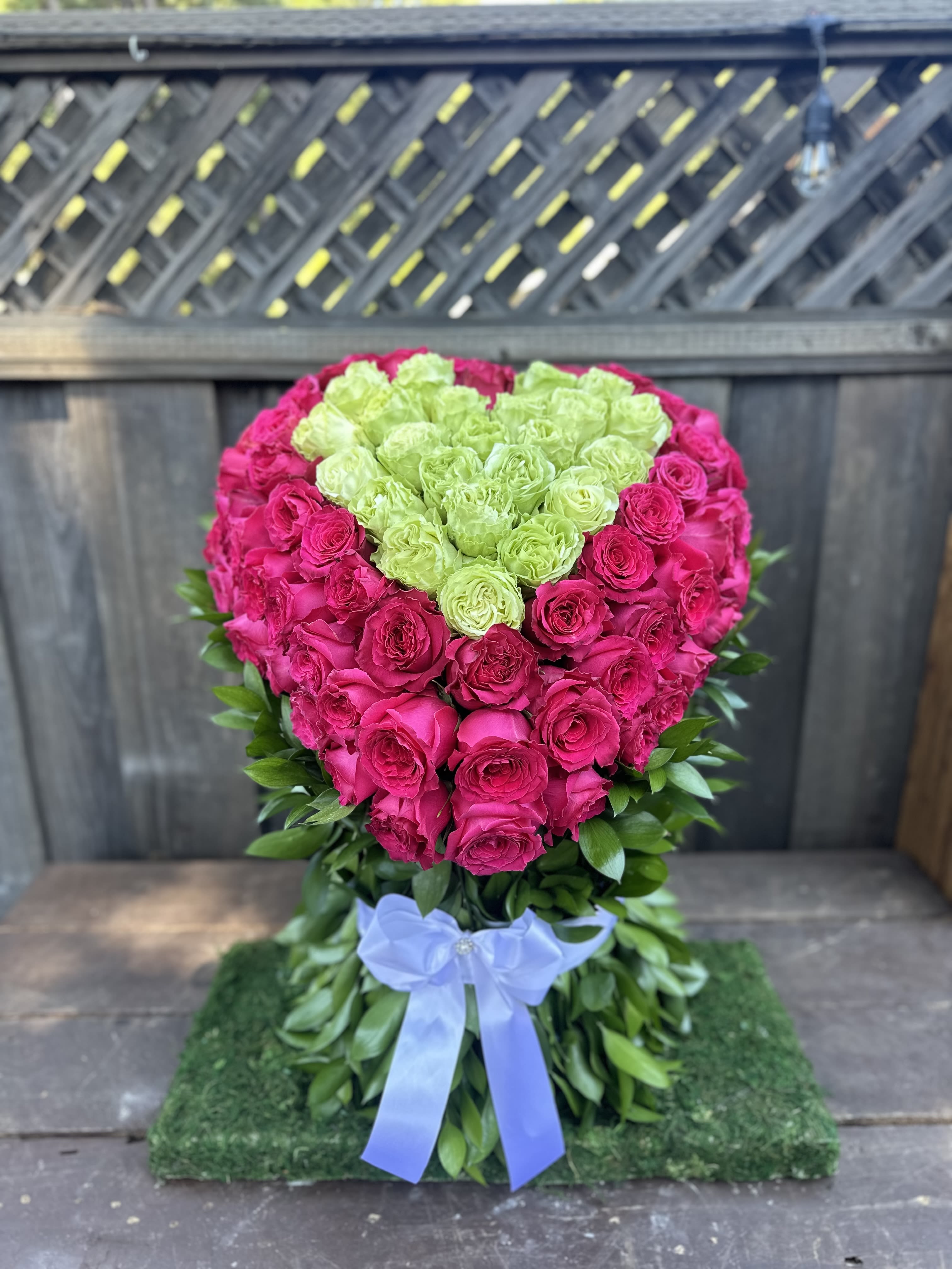 75 Heart Shape Hot Pink and Light green Rose by Pretty Petals Arrangements - Introducing our stunning 100 Heart-Shaped Hot Pink and Light Green Roses Standing Arrangement, a breathtaking centerpiece designed to elevate any occasion. At Pretty Petals Arrangements, each bouquet is meticulously handcrafted from scratch, ensuring that every petal is fresh and vibrant. This exquisite arrangement features an enchanting blend of lush hot pink roses symbolizing love and passion, complemented by delicate light green roses that add a refreshing touch. Perfect for celebrations, anniversaries, or simply to brighten someone's day, our unique heart shape design exudes elegance and thoughtfulness, making it a truly unforgettable gift. Let Pretty Petals create a floral masterpiece that speaks from the heart.