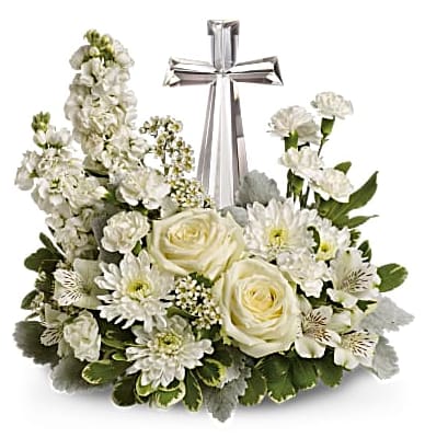Pure Peace - An elegant synthesis of peace upheld by faith. White blooms - including roses, alstroemeria, stock, carnations and waxflower - accented with dusty miller and variegated pittosporum around an exclusive Crystal Cross.