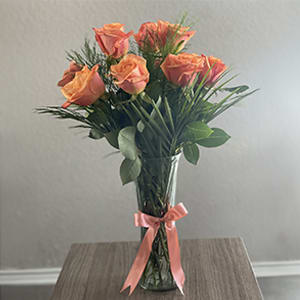 Blazing Beauty Bouquet - Elegant bouquet of long stem orange roses with assorted greenery all around on a tall clear vase with a bow.