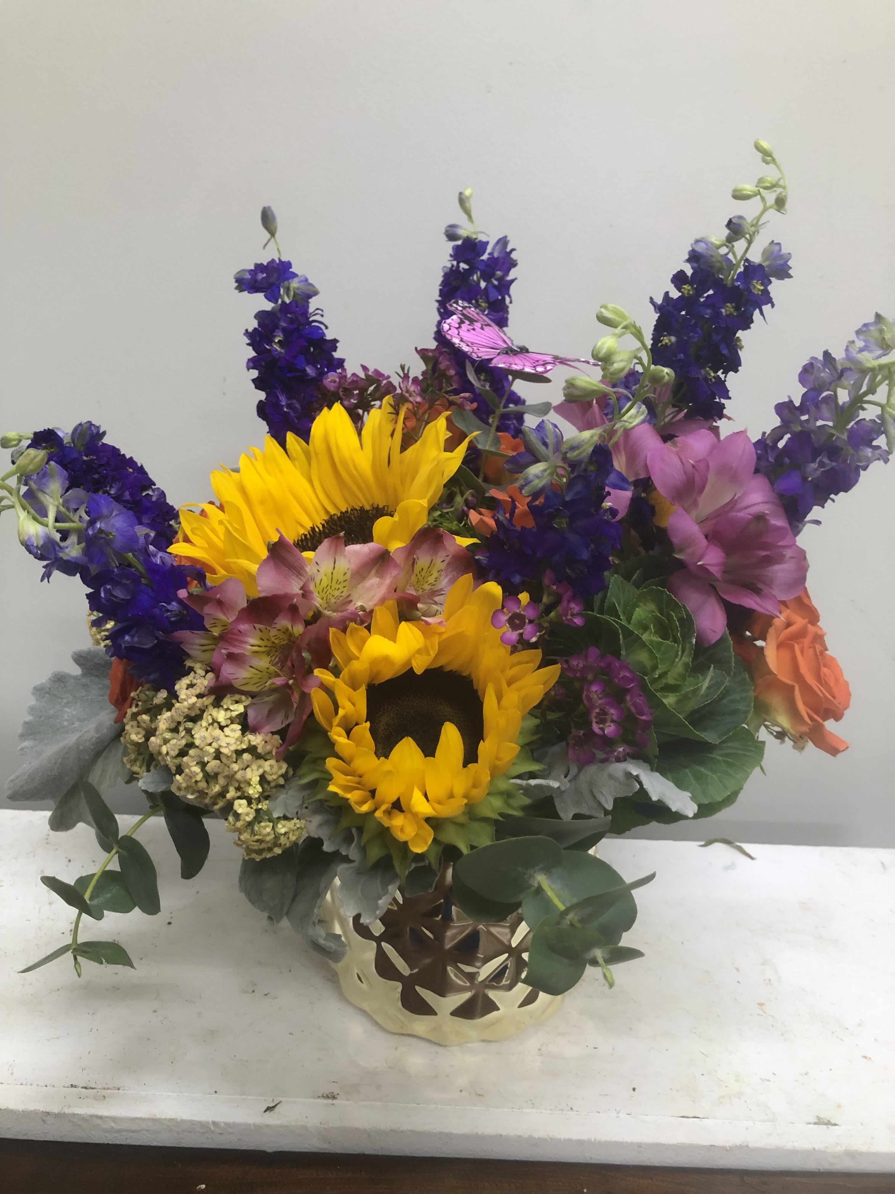 Sunshine Orange Delight - Sunflowers surrounded by orange roses, alstroemeria, and purple larkspur.