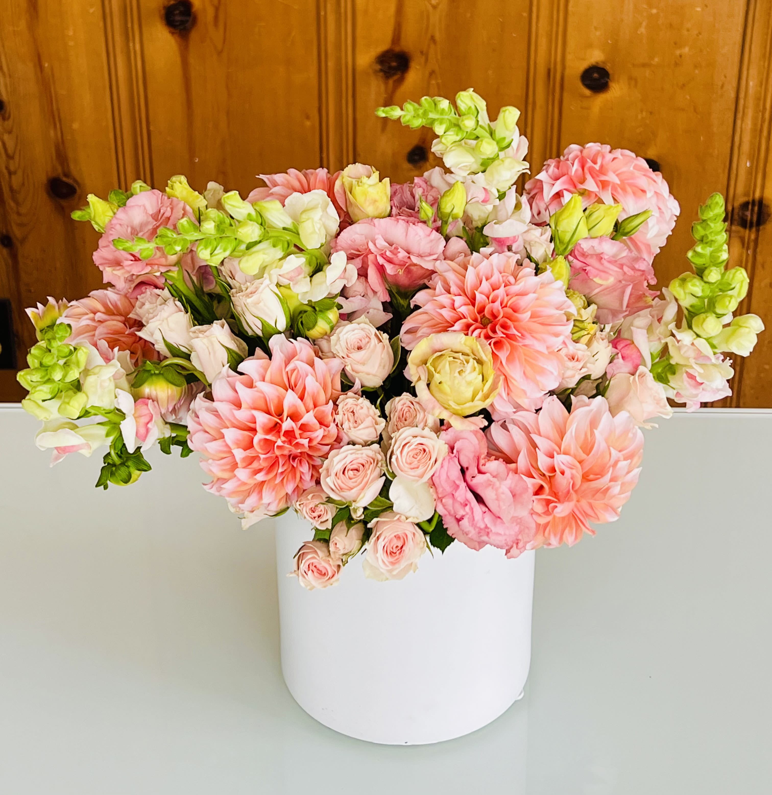 Dang Dahlia! - The Dahlia is the star of this show! Big, bold blooms with seasonal accent floral. Color may vary from peach, pink and white dominant. Depends on what Mother Nature sends us.