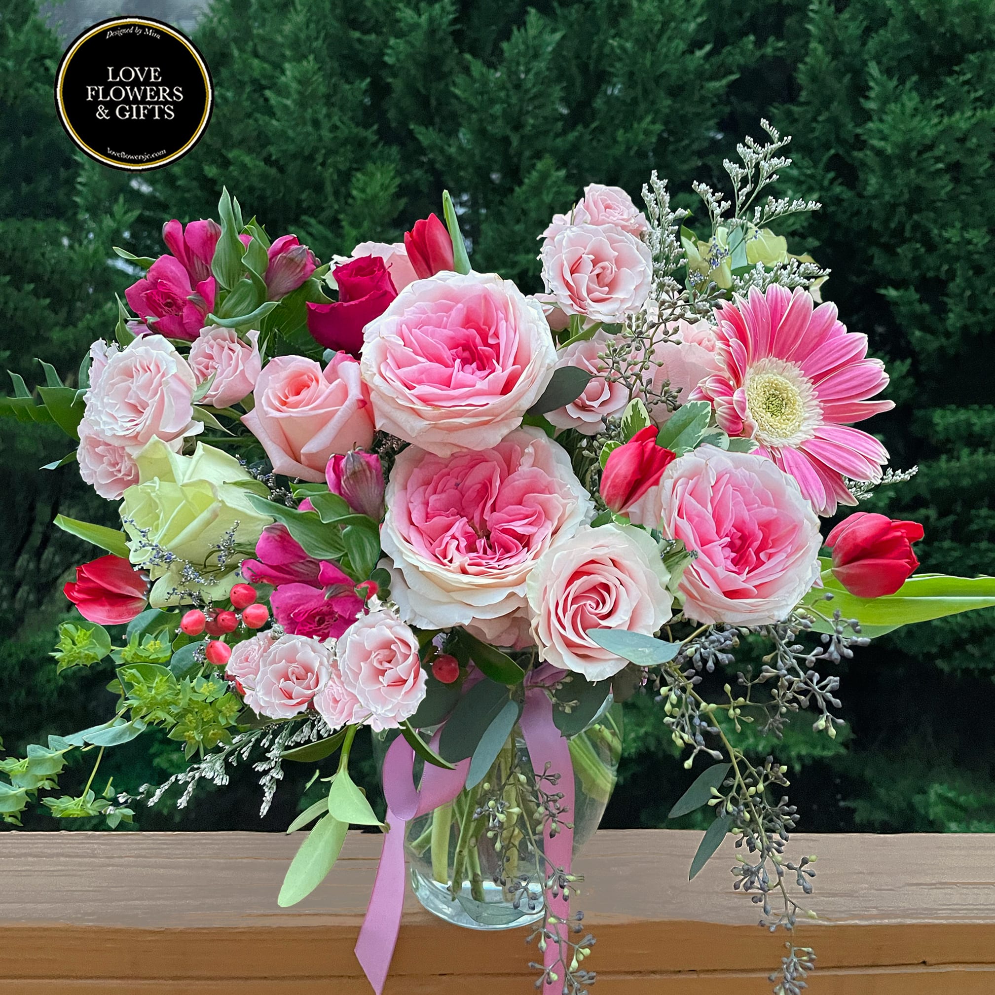 I Love You More  - Say Happy Anniversary and more with this lush sweet pinks arrangement made with garden roses, spray roses, tulips and more. 