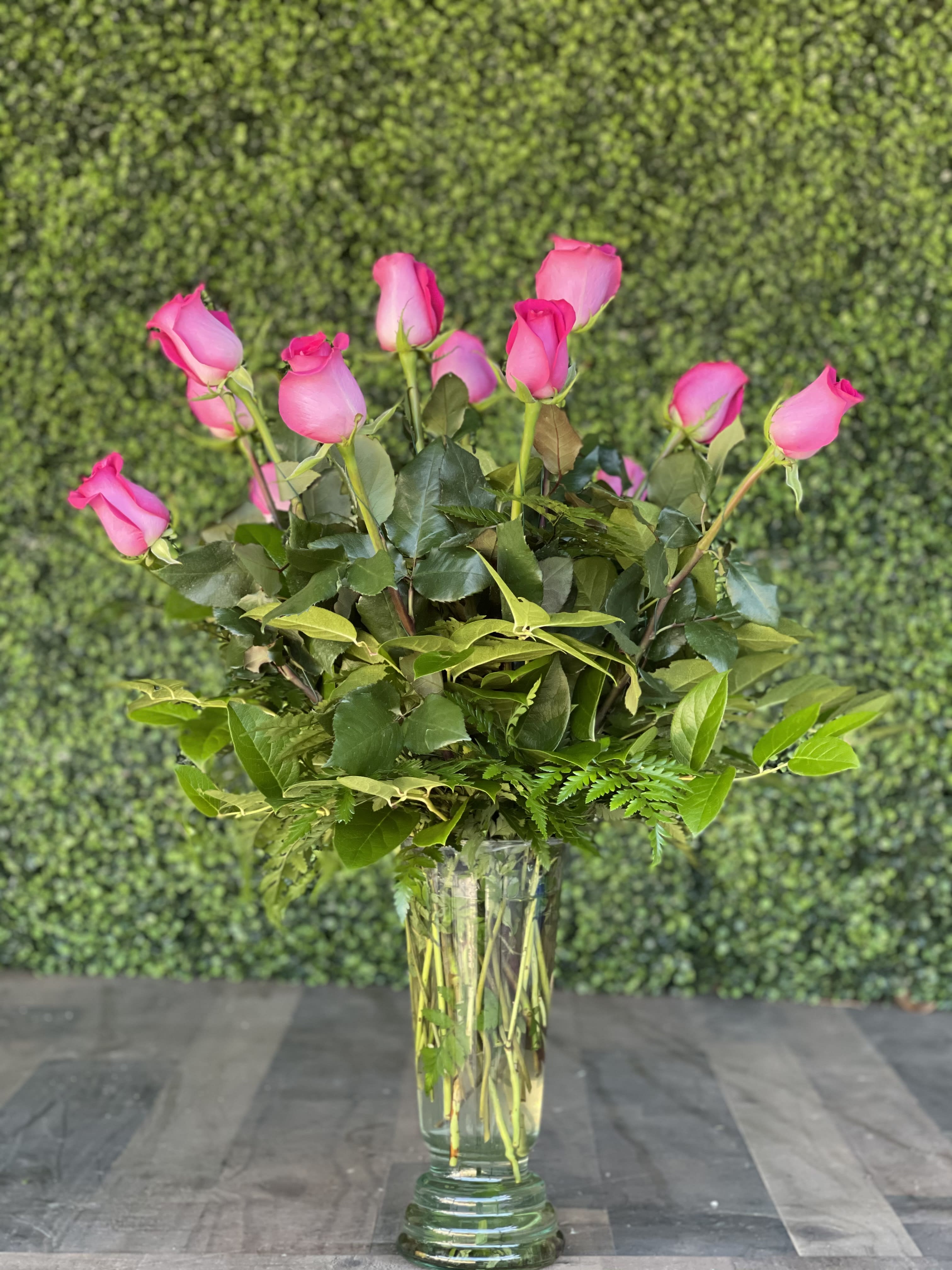 HOT PINK ROSES - A classic design of hot pink roses in an updated glass vase.