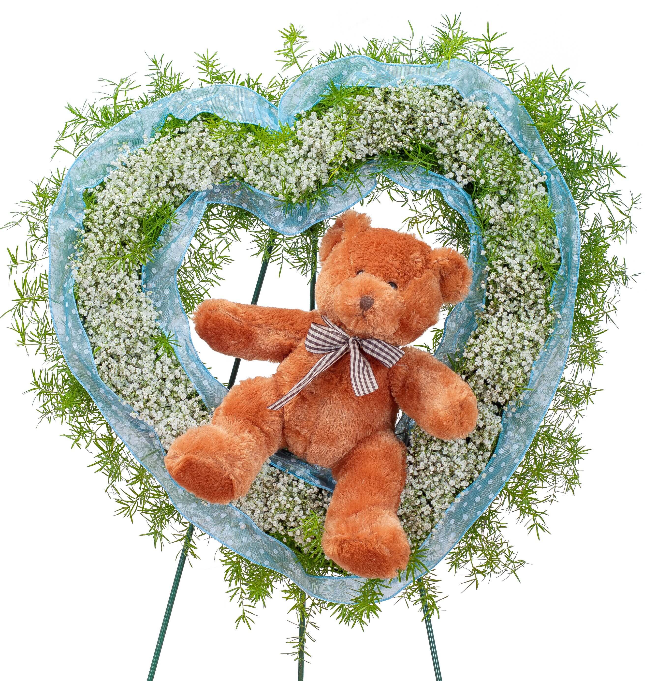 Tiny Angels Wreath in Blue Tiny Angels Wreath in Blue - A heart of sweet white baby's breath surrounded by blue ribbon with a plush bear seated inside is a perfect tribute for a tiny angel.