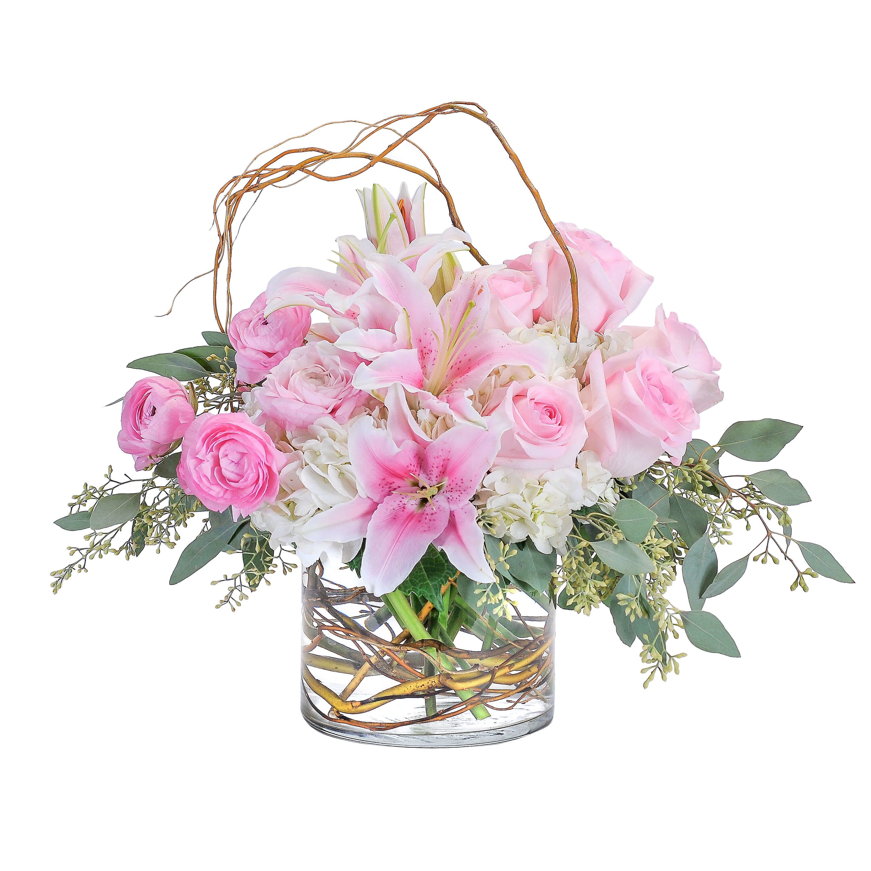 Peaceful Pink - In this peaceful and pink design, the curly willow encircles the combination of hydrangea, roses, lilies and ranunculus to draw attention to the premium delicate blooms.