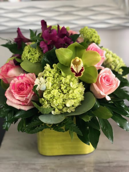 Sweetest Thing Sweetest Thing - A beautiful blend of pink, green, and purple blooms arranged into a glass vase with mixed greenery.