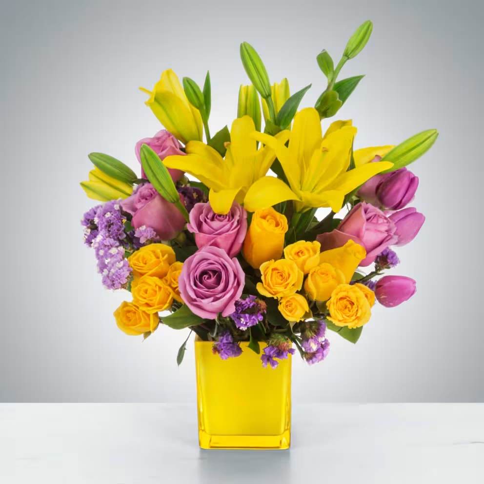 Sunday Afternoon by BloomNation™ Sunday Afternoon by BloomNation™ - This arrangement is a sweet surprise for any recipient. Featuring a selection of yellow and purple flowers in a yellow vase, this arrangement is springtime in flower form and a great gift for Easter or Passover. Approximate Dimensions: 13"D x 16"H