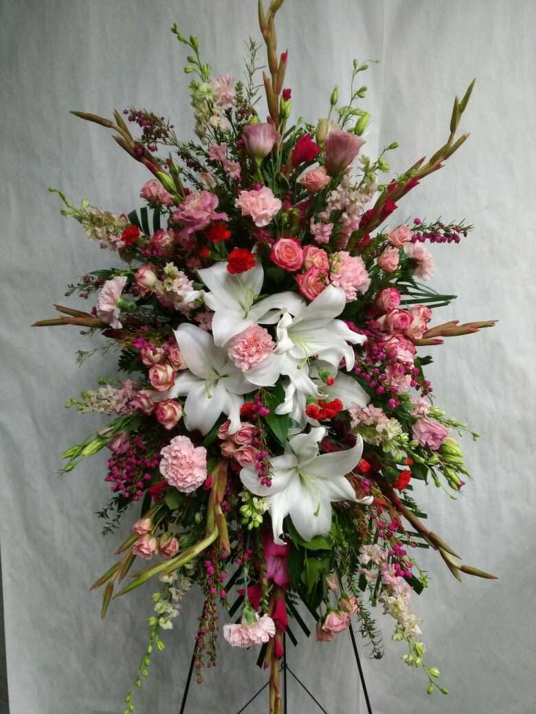 Loving Memory Floral Spray Loving Memory Floral Spray - Shades of pinks and whites. Designed with honoring your loved one. A bountiful mix of seasonal pink flowers in season, fresh from the farms.