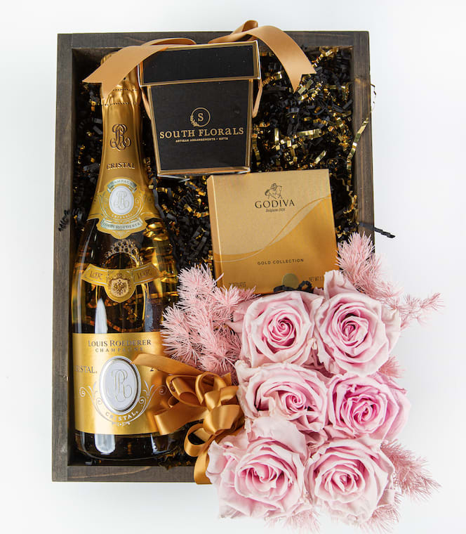 Louis Roederer Opulent Cristal Champagne Gift Box - GBLR - Louis Roederer Opulent Cristal Champagne Gift Box The Louis Roederer Opulent Cristal Champagne Gift Box includes a bottle of Louis Roederer Cristal Champagne, 4pc Godiva Chocolate, Scented Candle Wrapped in Satin Ribbons, Preserved Roses on a bed of French Vanilla shred. The Preserved Roses are frozen in time and will remain as a beautiful keepsake.