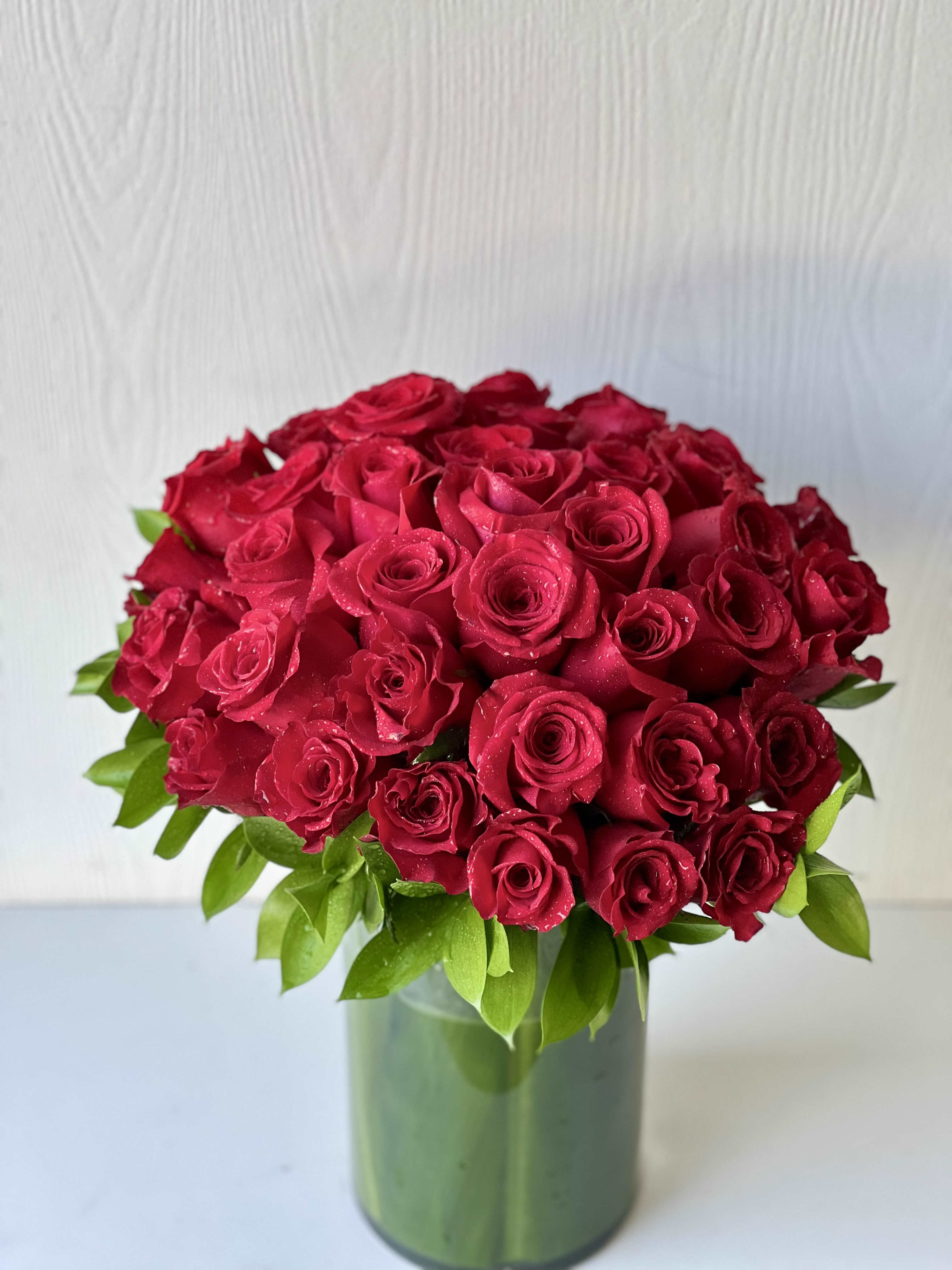 36 Stems of Red Roses - Our stunning 3 Dozen Red Rose arrangement is the epitome of romance and passion. Each of the three dozen roses has been expertly chosen for its deep, bold red color, evoking a sense of love, desire and devotion. Whether you're surprising a special someone on a special occasion, expressing your love and appreciation or just because, these roses make the ultimate statement of love. From anniversaries to Valentine's Day, or simply as a gesture of love, the 3 Dozen Red Roses are a classic and timeless way to express your deepest feelings. 