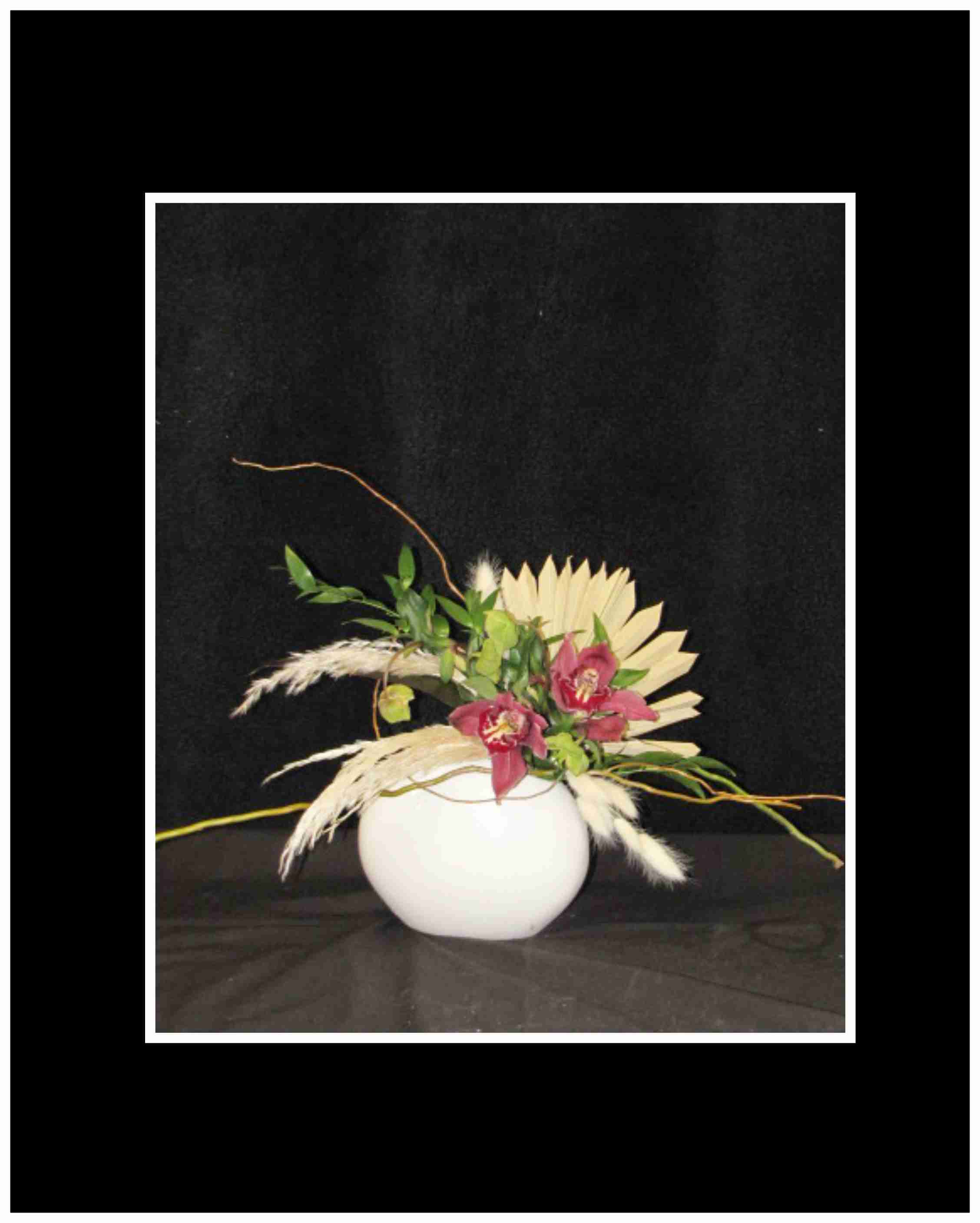 Sophistication Bouquet Sophistication Bouquet - The Sophistication Bouquet is for any occasion, with the minimalist in mind and is done in a keepsake vase with a mixture of dried and fresh flowers Approximately 8"H x 16 W