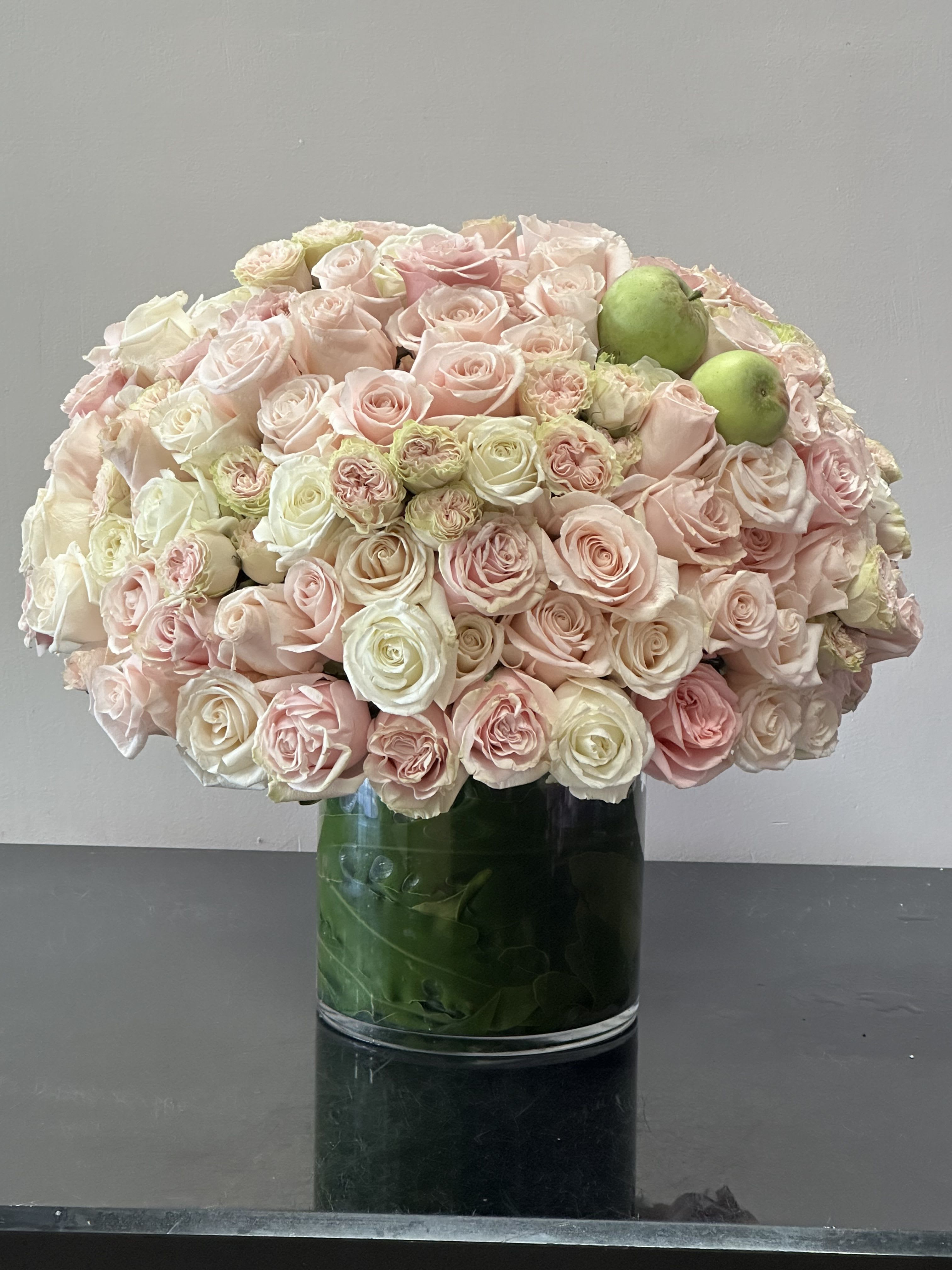 Blushing Rose Blushing Rose - A perfect blend of blush pink and ivory roses in classic round shape with greens emerged in vase Some florals are seasonal, if particular flower will not be available due to season, we will substitute for similar flower, composition, color pallet and value of the arrangements as closely as possible. All effort to create a floral arrangement as close to the photo shown, the actual arrangement may vary slightly in its appearance from the photo shown. If you have any questions about your order, we welcome you to call us in or email