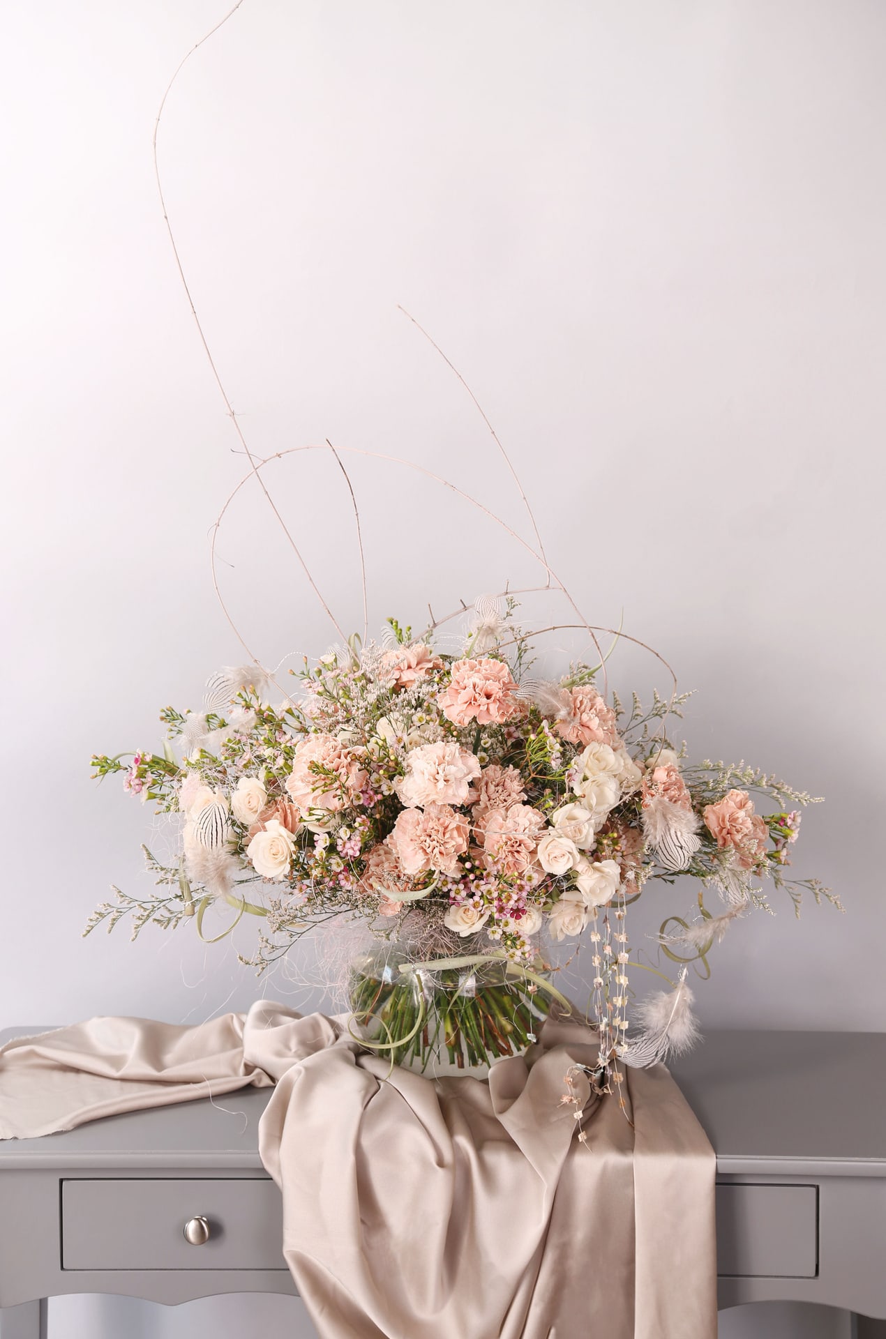 Blush  tendor flower - A soft blush, sand color way which express a very gentle lovely feeling to your loved and family. This is an arrangement for mom, family member or friends whoever you love and appreciate; this arrangement create with Spray Rose and carnation which is very versatile and easy for eyes for everyone. The handmade wiring feather garland decorate detail craftsmanship to add a touch of unique and elegant. The arrangement can arrange in 8&quot; ball vase purchased as pic shown  Disclaimer: Photo just represent the overall style, look and feel, which may not be able to identically replicate in some instance. We will only substitute item of equal value or higher value. 