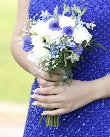 Sophia's Blue Breeze Hand Held Boutique  - White Roses with Blue accent Flowers and Babies Breath. Deluxe choice will include more flowers. Premium choice will include more flowers with fairy lights for a beautiful glow.