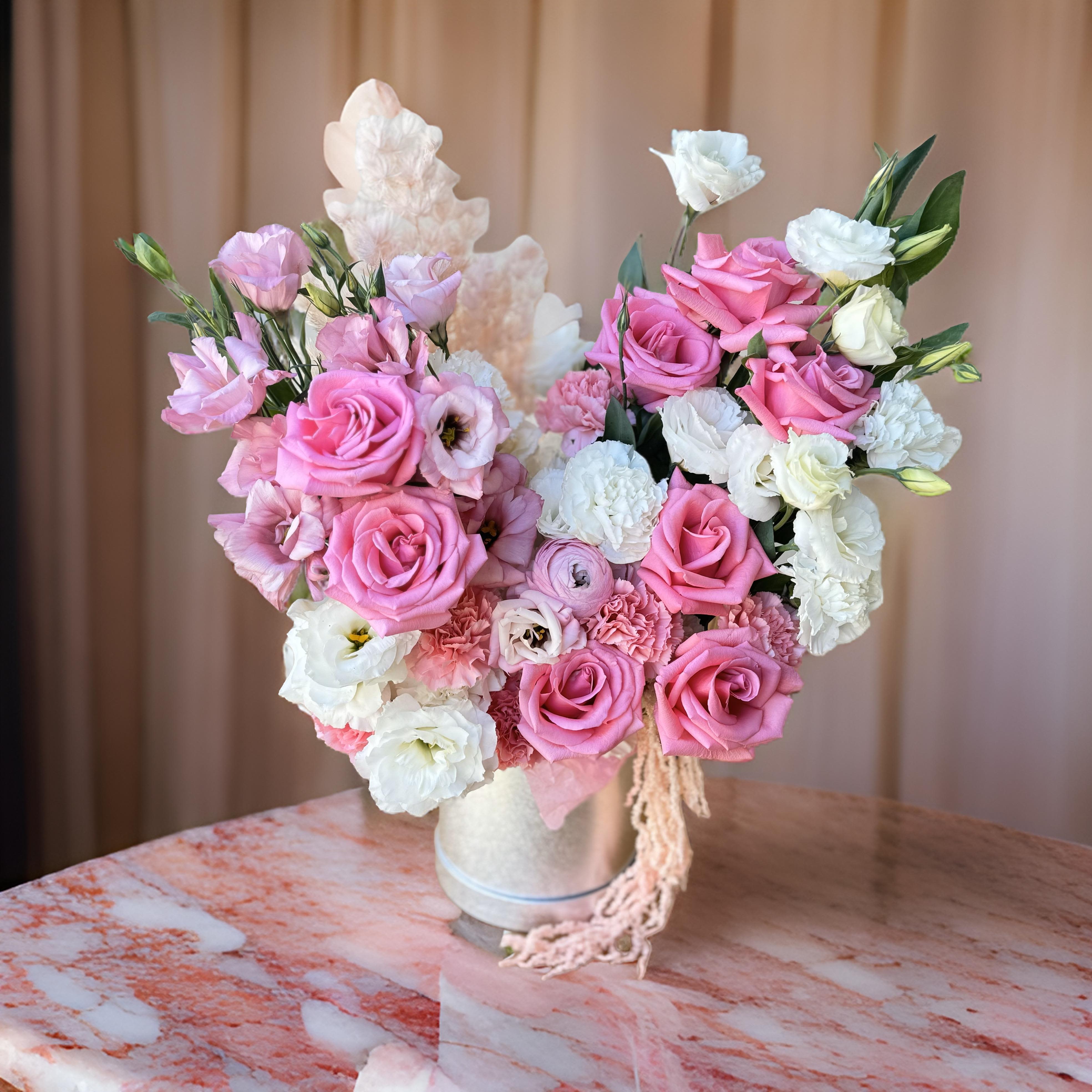 Hollywood Romance - This beautiful arrangement features pink roses, delicate white lisianthus, and soft carnations in a stylish gift box, perfect for birthdays, anniversaries, or any special occasion in Los Angeles. The blend of pink and white flowers creates a romantic and sophisticated look, making it an ideal gift to show love and appreciation. Our flower delivery service in Los Angeles ensures fresh and beautifully arranged blooms. Order this elegant bouquet today to surprise someone special with a heartfelt gift.