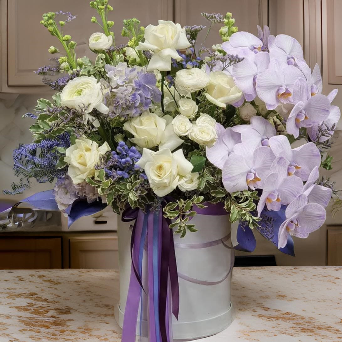 Pure Harmony - The &quot;Pure Harmony&quot; flower box brings together the timeless beauty of pristine white roses and the exotic allure of orchids. This luxurious arrangement exudes grace and sophistication, making it an exquisite choice for those special moments when only the finest will do. Whether you're celebrating a milestone, expressing deep affection, or sending a message of purity and elegance, this bouquet is a perfect expression of refined taste and enduring love.