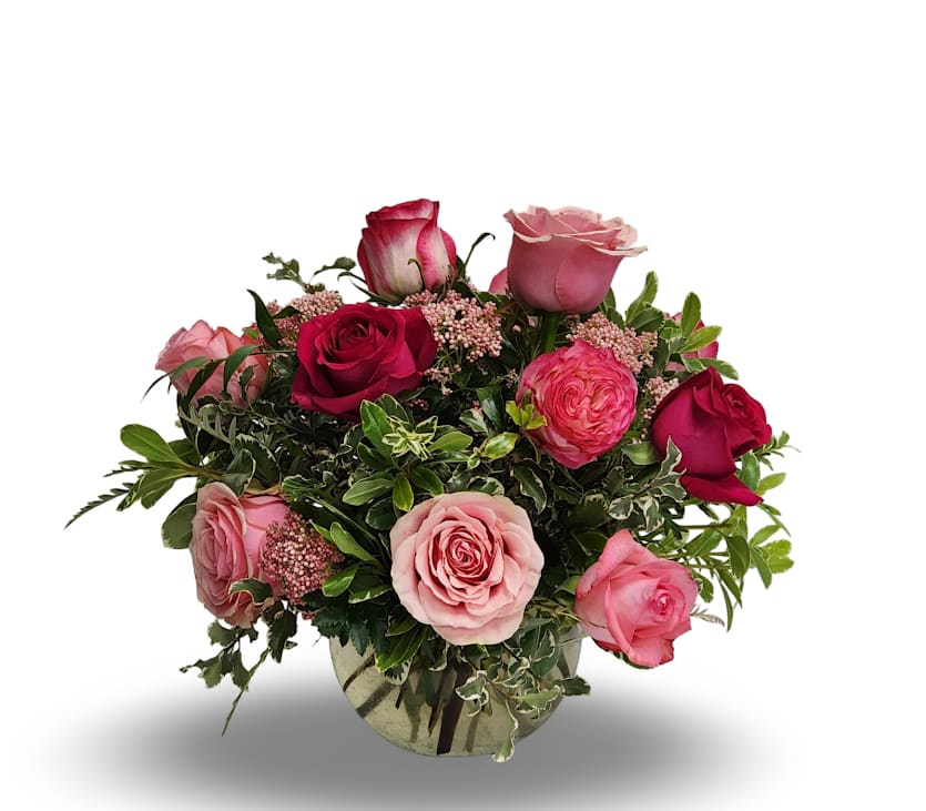 Mixed Pink Rose Bowl Mixed Pink Rose Bowl - This lush, garden-style arrangement overflows with elegance and charm. A delightful mix of pink roses in various shades, ranging from soft blush to deep rose, is artfully arranged with seasonal greenery and delicate filler flowers in a clear glass bowl. Whether celebrating love, friendship, or simply brightening someone’s day, this piece brings warmth and grace to any space. Please note: The arrangement may include different pink rose varieties than those shown in the photo, but will always feature a beautiful blend of pink tones complemented by fresh filler flowers.