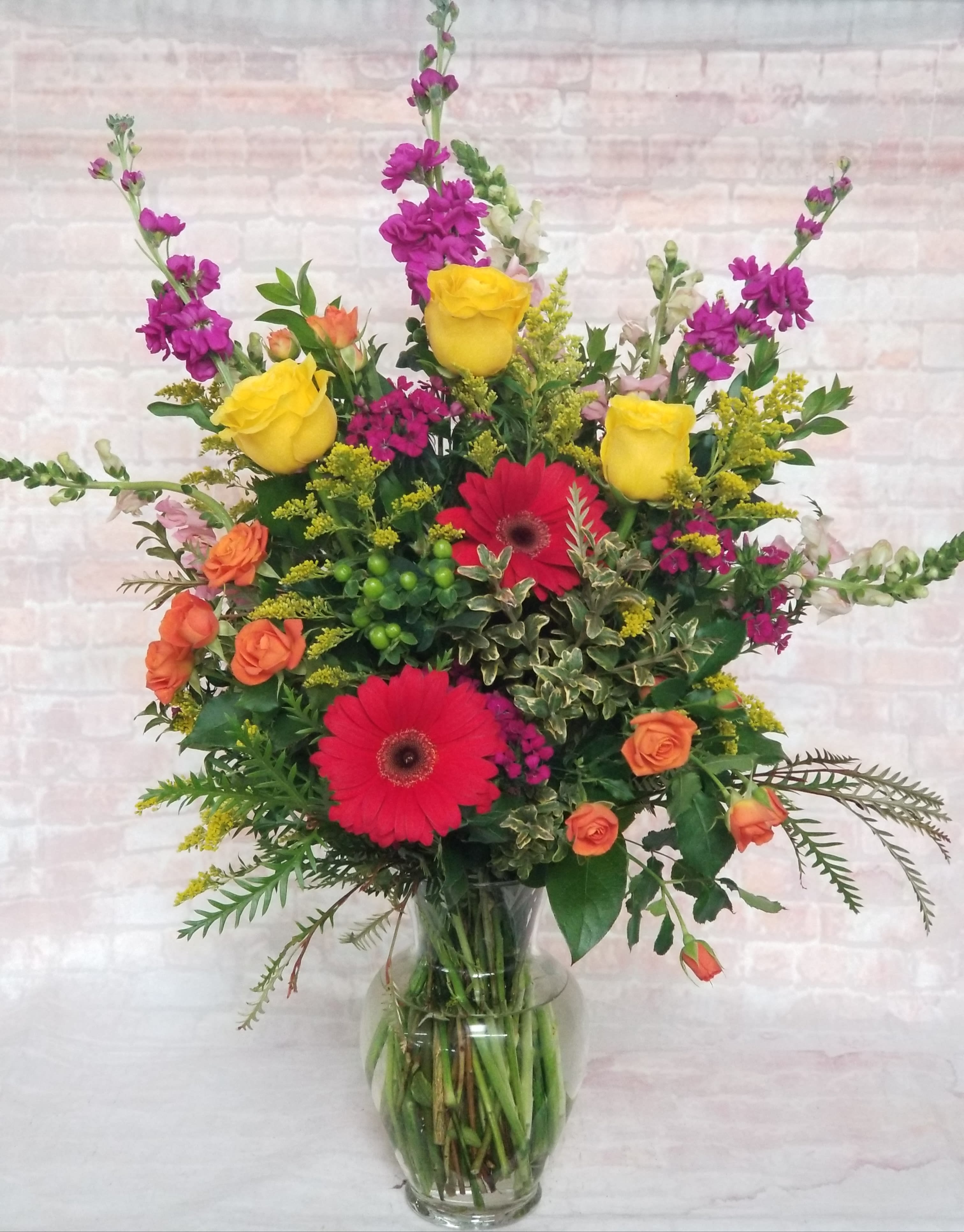 Spring Break Spring Break - Select this bright and happy arrangement that features roses, gerbera daisies, spray roses, and more!