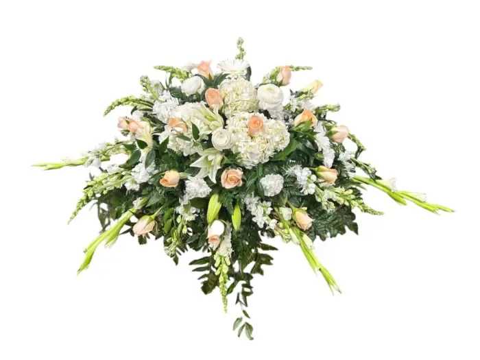 Serene Sentiments Florist Choice Casket Spray - The &quot;Serene Sentiments Florist Choice Casket Spray&quot; is a heartfelt expression of love and remembrance, carefully crafted by our skilled florists to honor the life of your beloved. This exquisite arrangement features a thoughtfully curated selection of blooms, chosen for their timeless beauty and symbolic significance. Please let us know if you want any specific flowers or colors incorporated into the arrangement. Each one is handcrafted with hand-selected flowers.